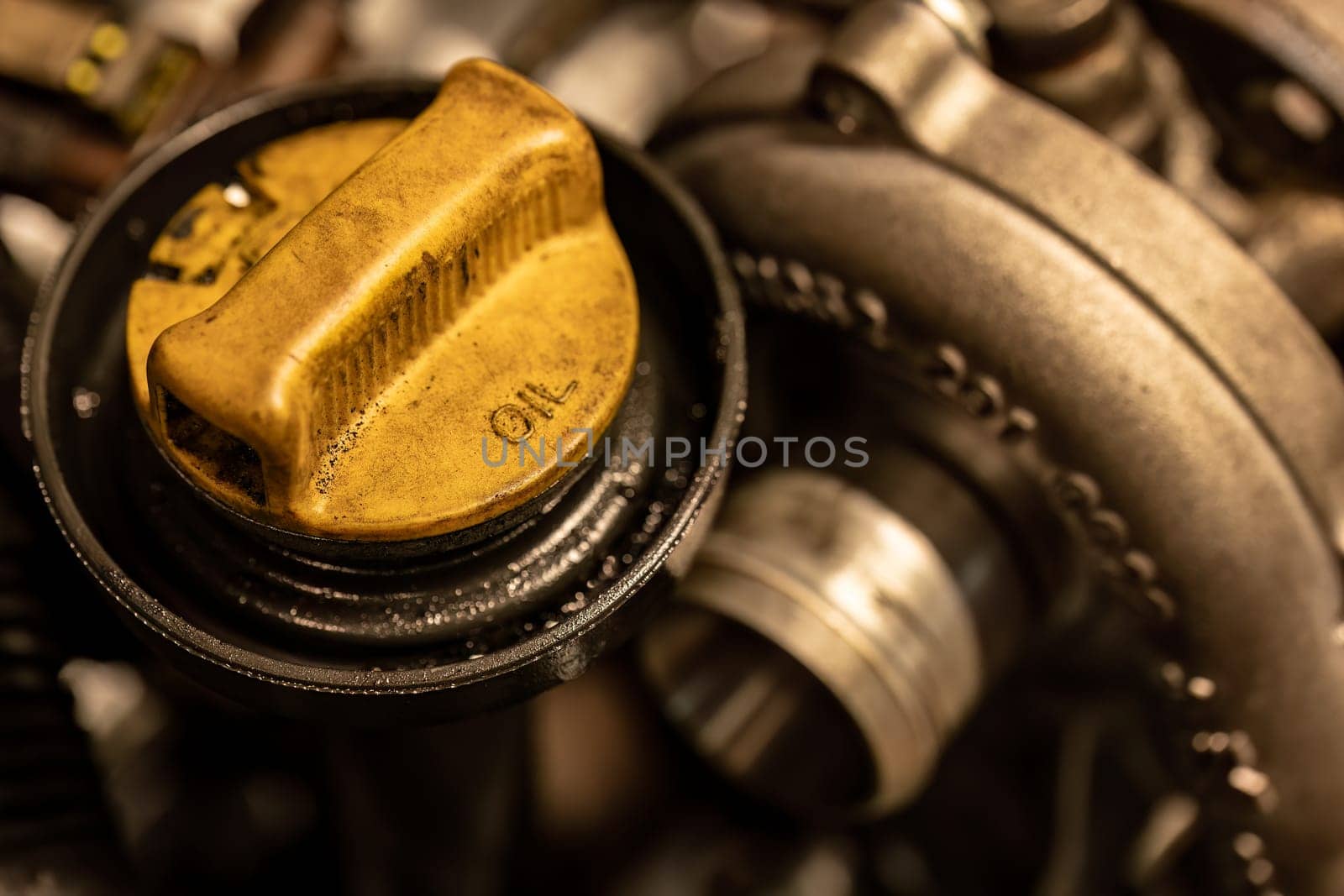 Photo shows a dirty oil cap on a car engine, symbolizing the urgent need for vehicle maintenance.