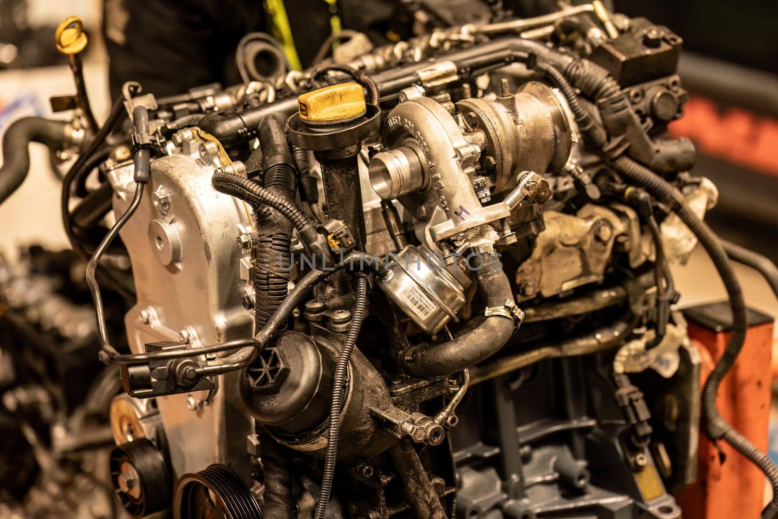 A photo capturing the intricate details of a dismantled car engine, exposing its inner workings.