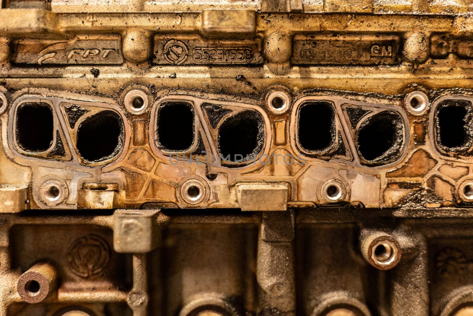 A photo showing dirty intake manifolds in a car engine, impacted by exhaust gas recirculation (EGR) effects.