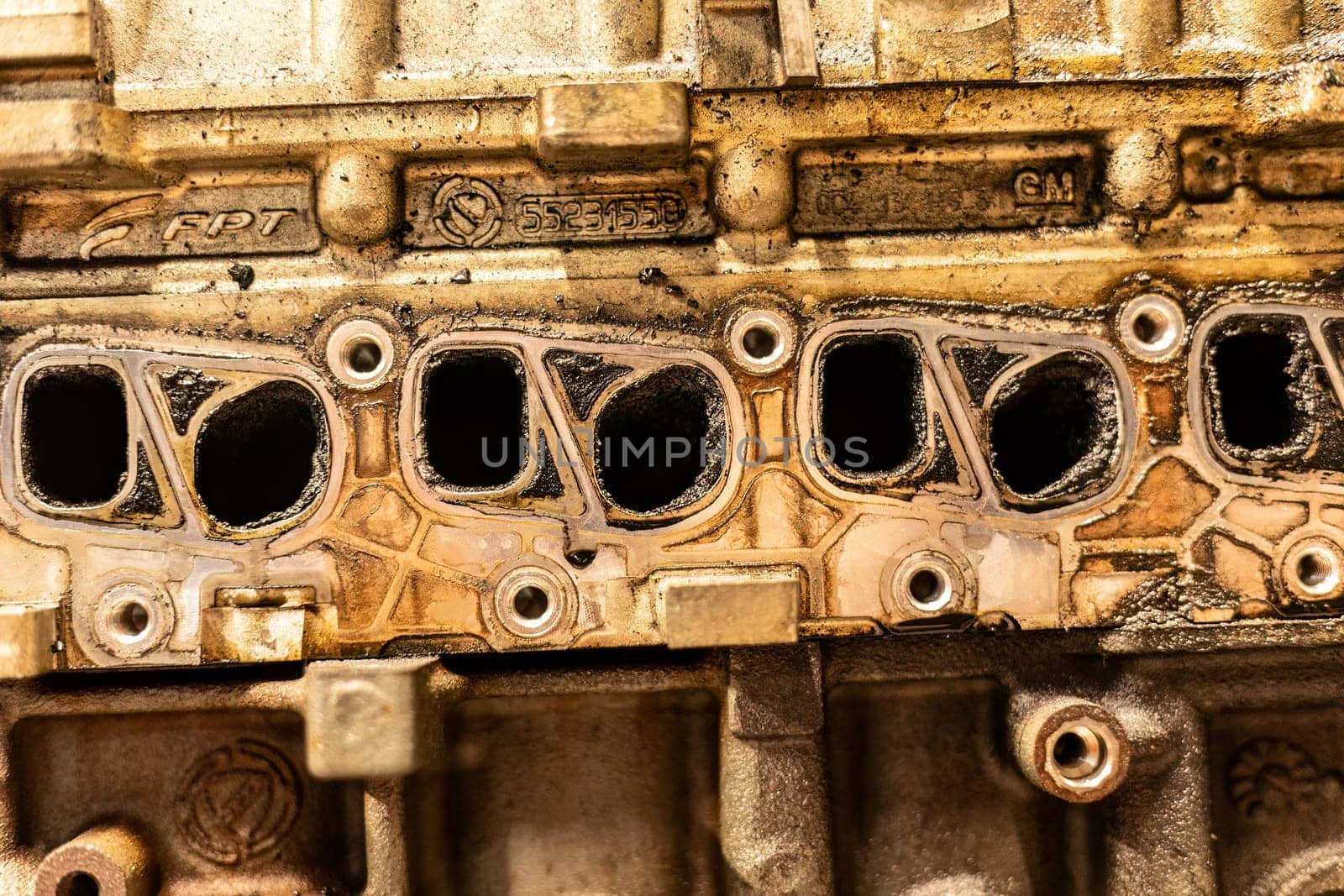 A photo showing dirty intake manifolds in a car engine, impacted by exhaust gas recirculation (EGR) effects.