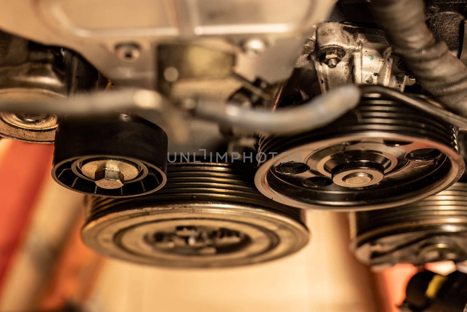 A close-up photo capturing the detailed view of a pulley in a car engine, epitomizing maintenance concepts.