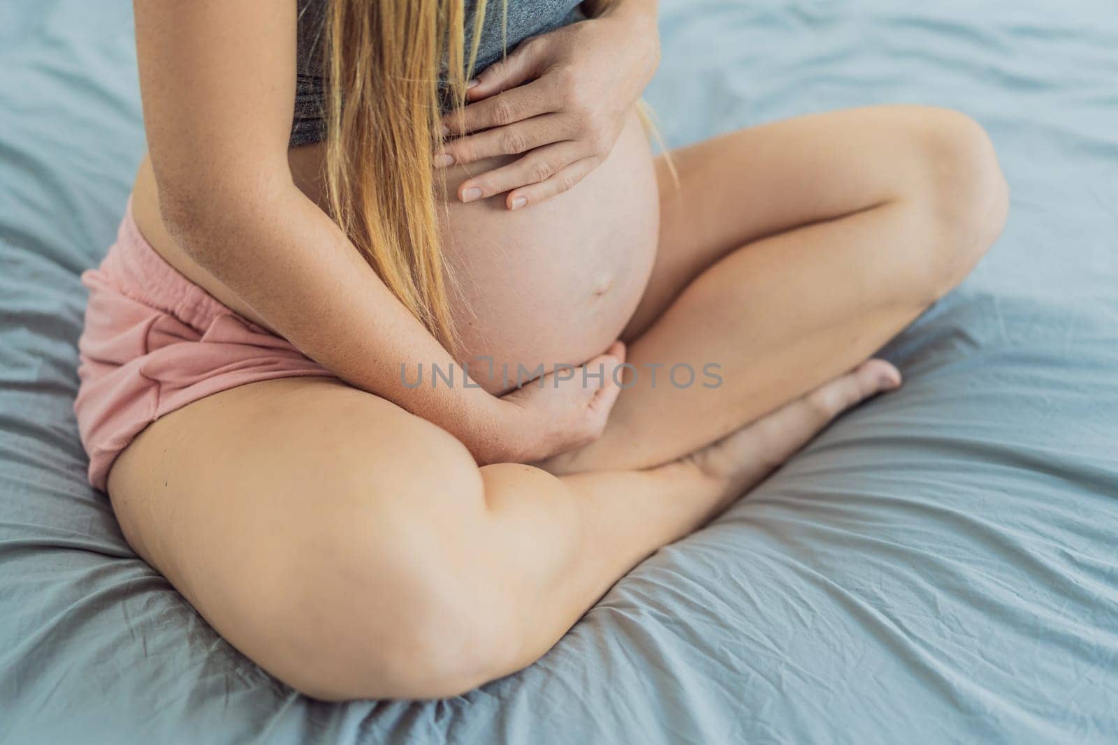 Expectant woman finds serenity in pregnancy, listening to affirmations and meditating for calmness by galitskaya