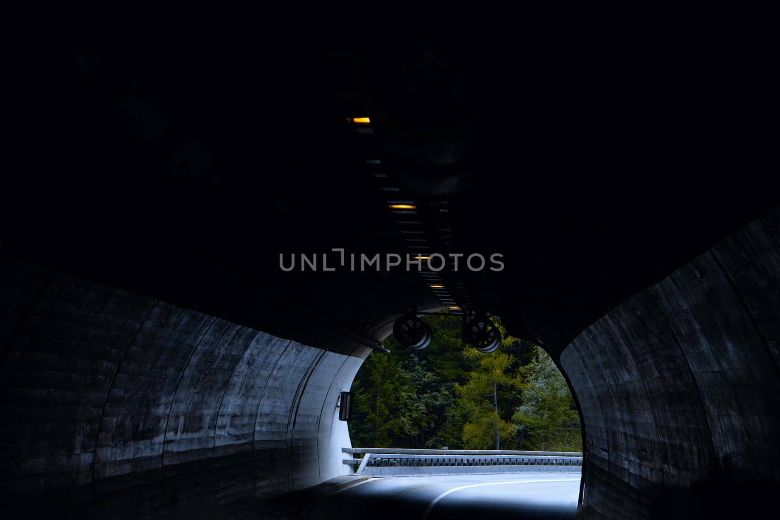 Emerging from Darkness: The Enigmatic Journey Through a Tunnel with Light at the End. High quality photo