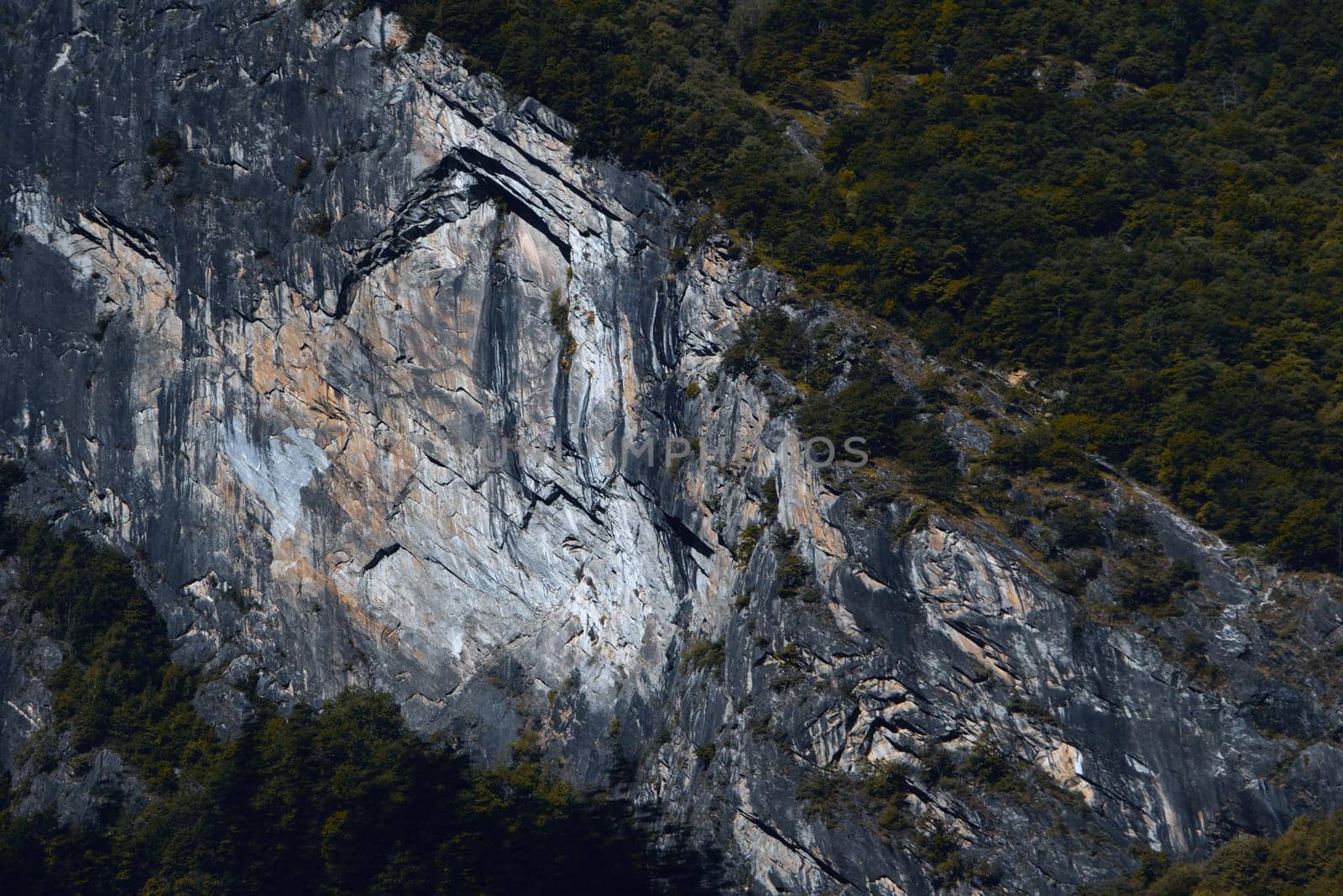 Geological Marvel: The Steep Rock Face of a Mountain, Marked by Time and Nature's Artistry. High quality photo