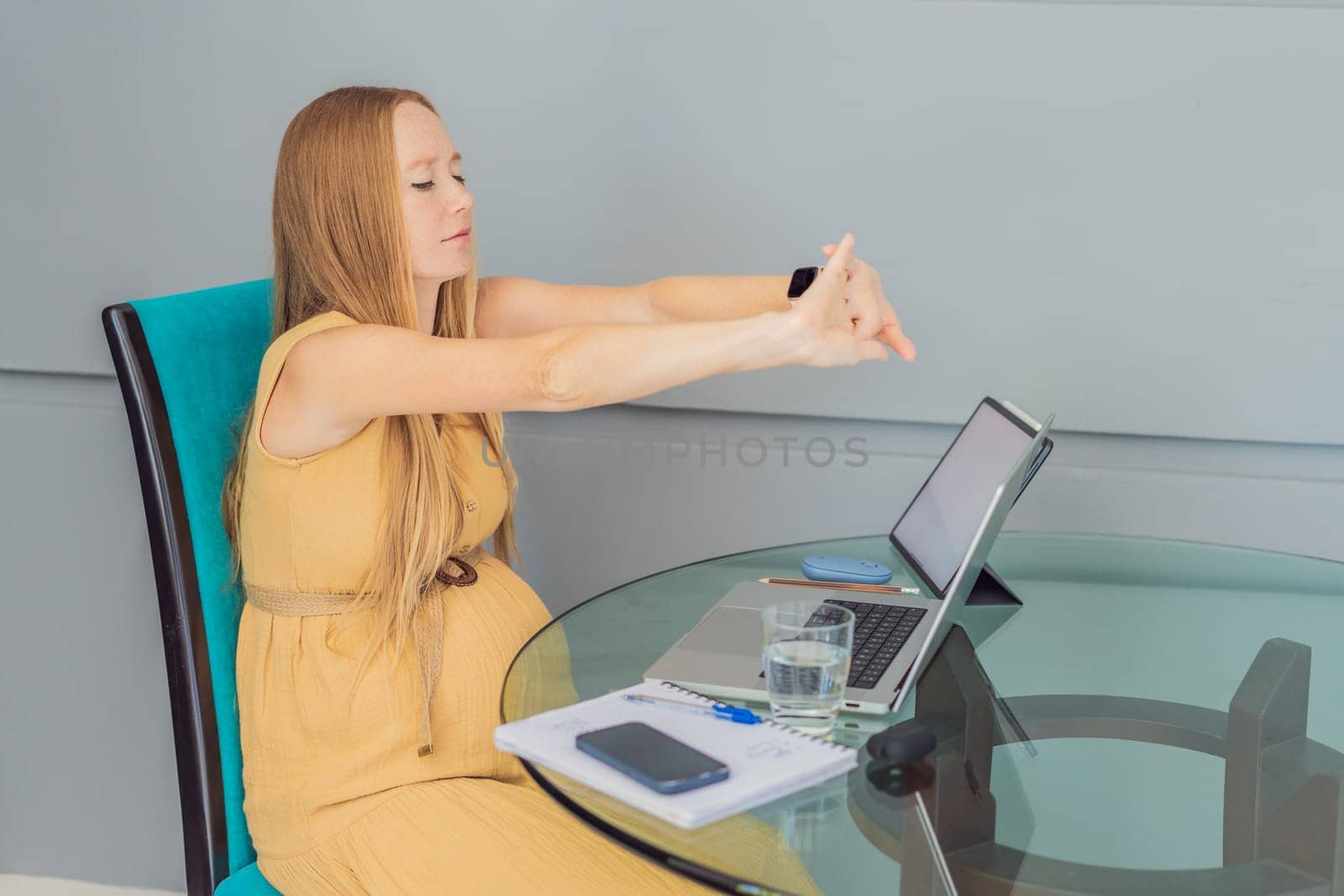 Beautiful pregnant woman working on laptop. Young businesswoman working in her office.