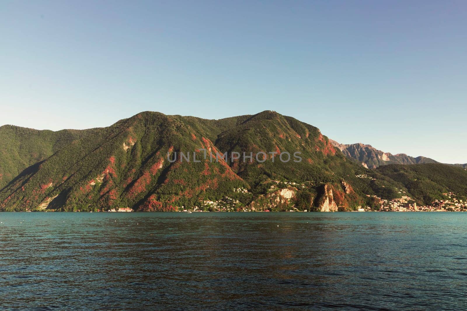 Lakeside Serenity with Red Foliaged Hills. High quality photo
