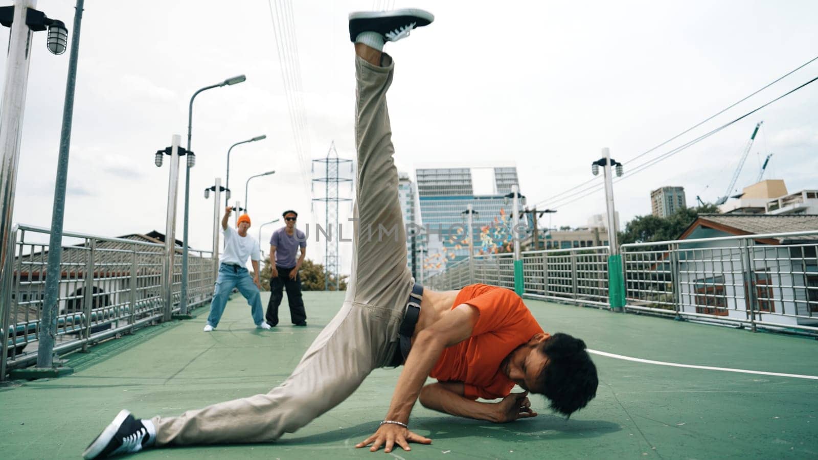 Young happy hipster perform break dancing or foot step with friend. Sprightly. by biancoblue