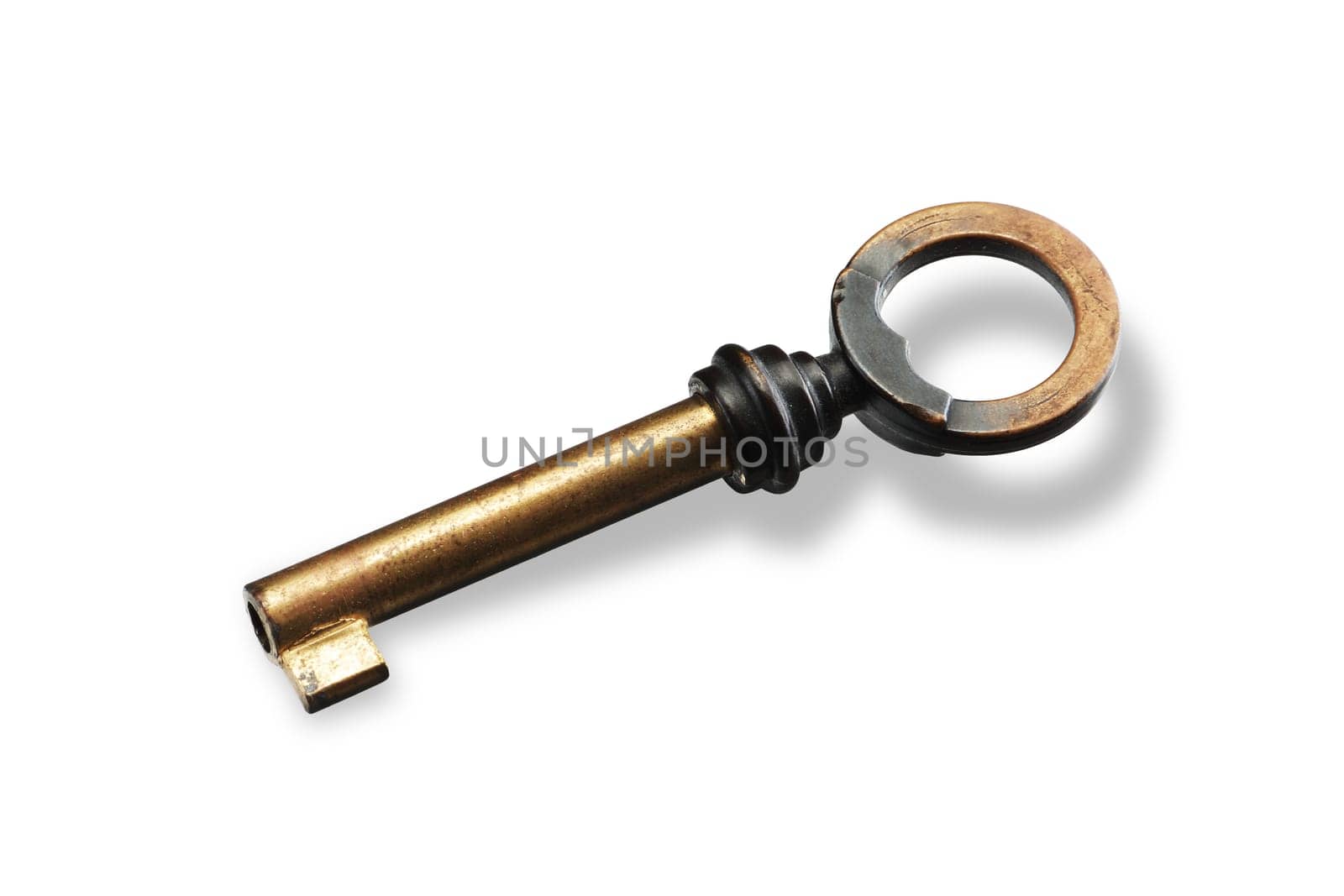 A brass key on white background with shadow