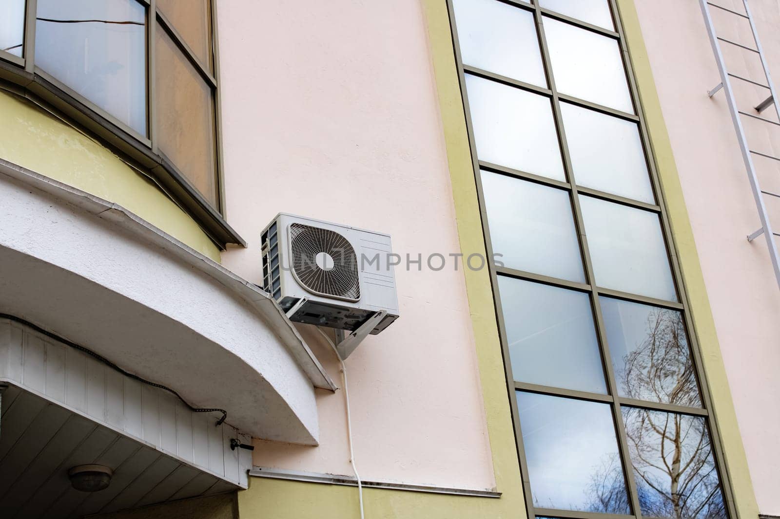 Air conditioning on wall of modern building with windows by Vera1703