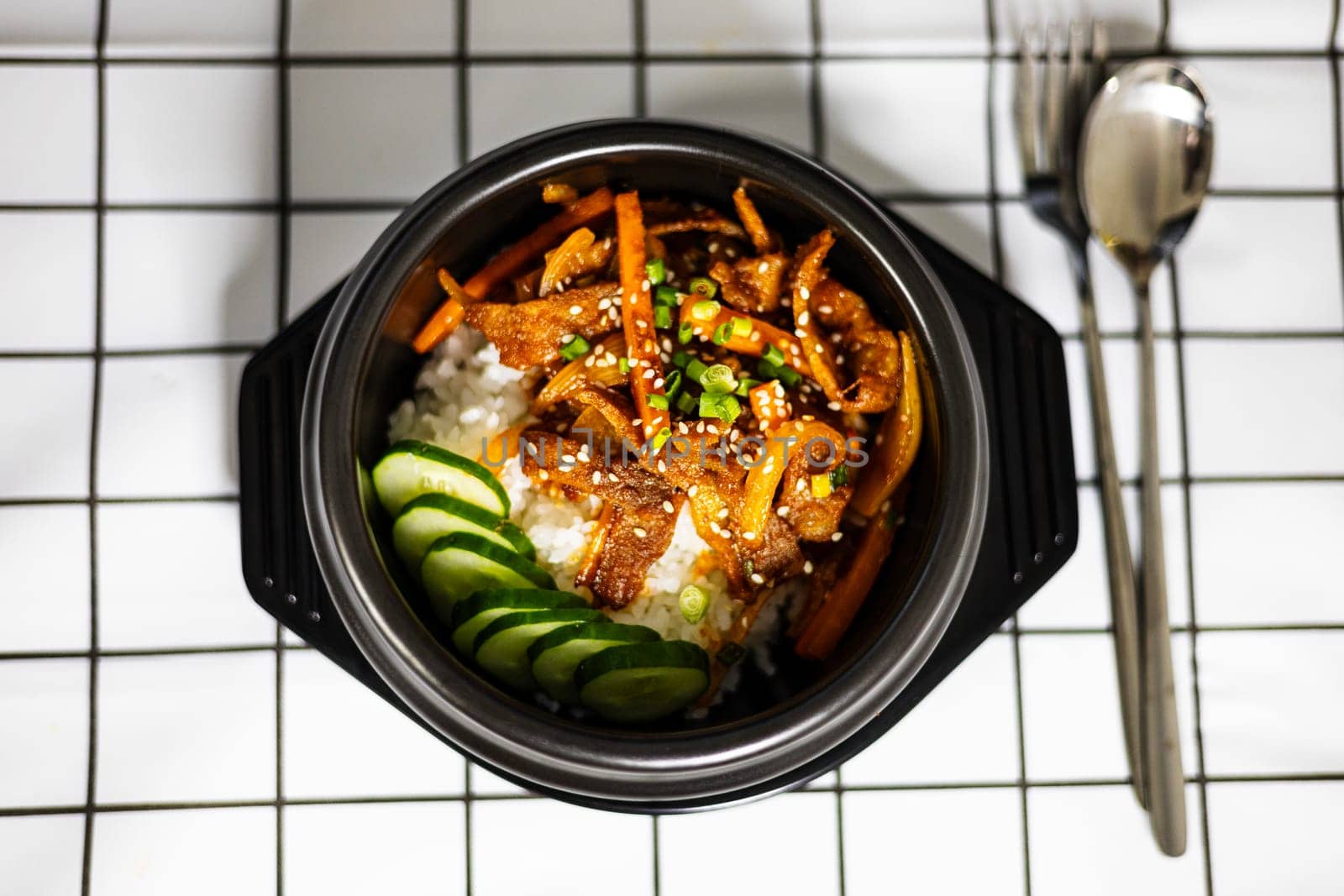 Rice And Stir Fried Pork With Korean Sauce. stir-fried pork with kimchi on topped rice - Korean food style.