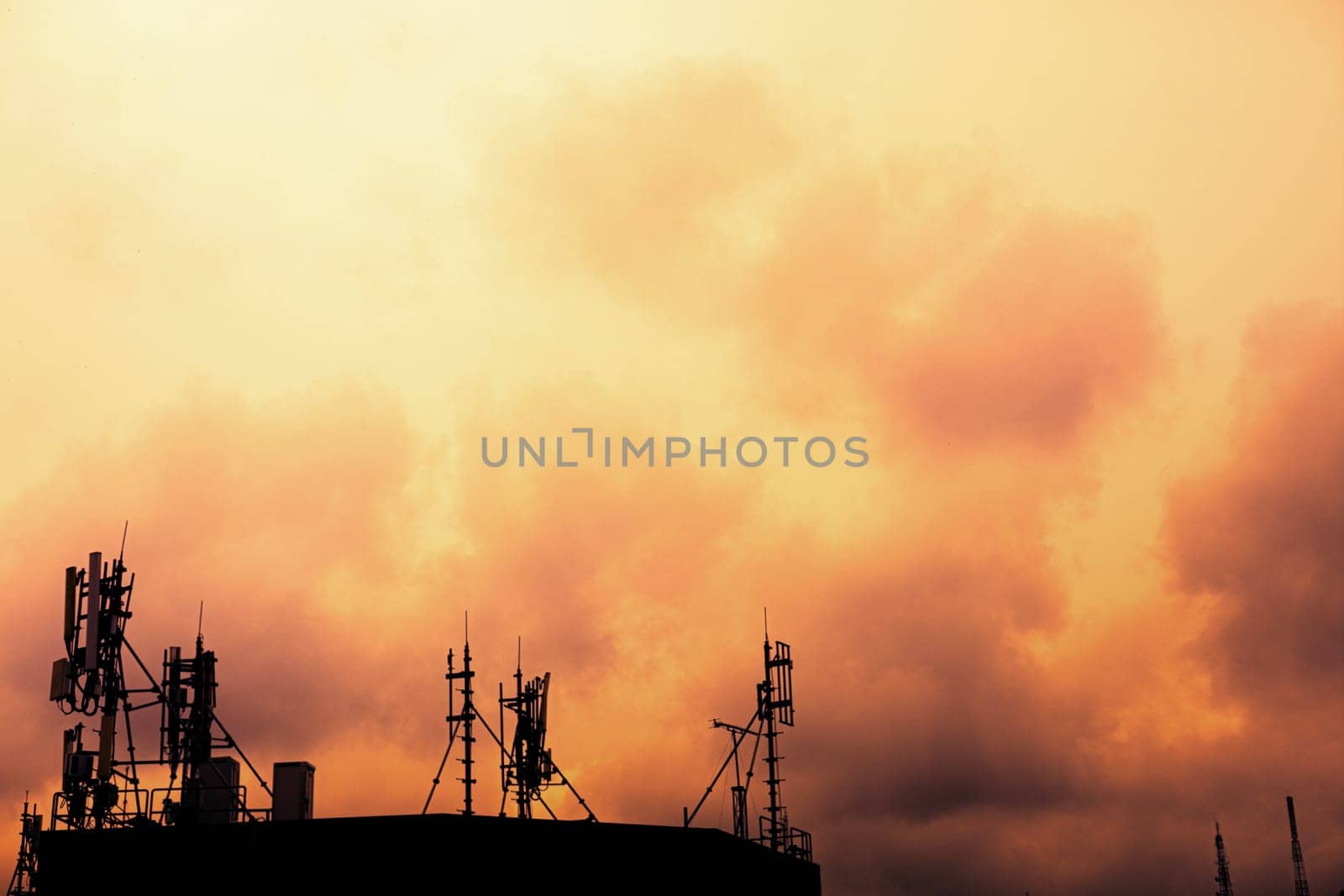 Abstract telecommunication tower, antenna and communication and satellite dish at sunset sky background.