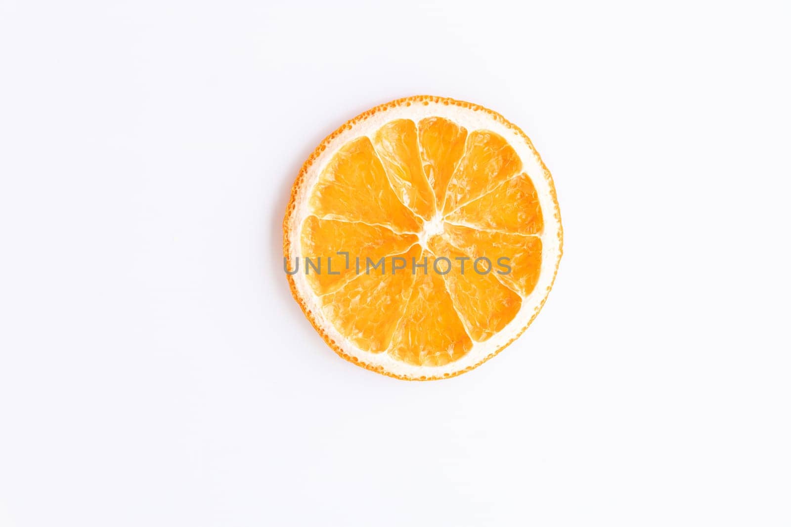 flat lay of piece of dried round ripe orange. fruit chips on white background. healthy sweets concept, diet, isolate, top view by Leoschka