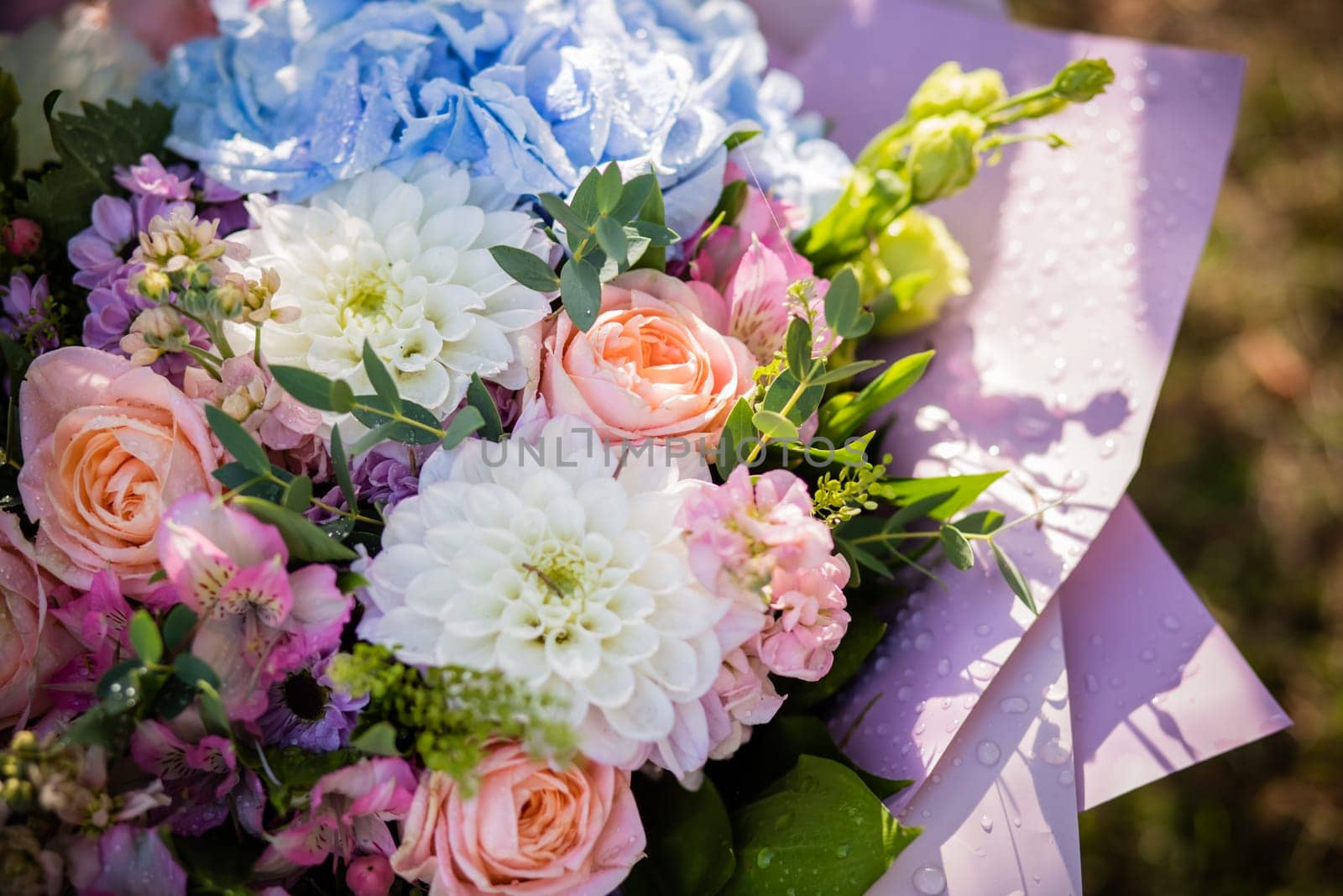 Beautiful wedding bouquet of bride wedding flowers fresh pink roses and alstroemeria bridal decoration. Fresh wedding flowers in summer day.