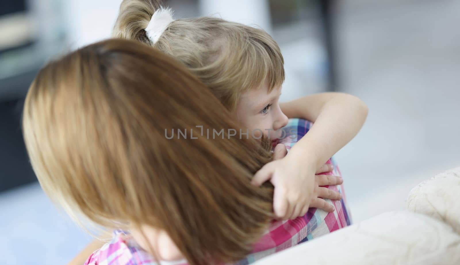 Portrait of mother and daughter hugging, mother comfort little kid, warm precious family moment. Kid spend time with parent. Family relationship concept