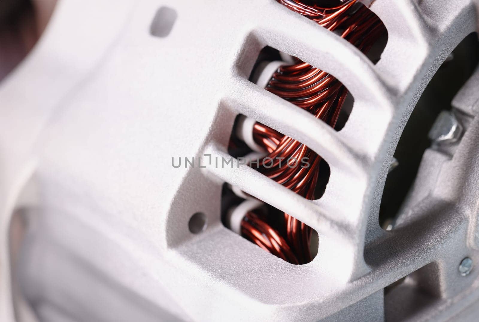 Close-up of electric motor stator, electric induction motor under repairing, armature. Detailed picture of winding coil. Fixation, replacement concept