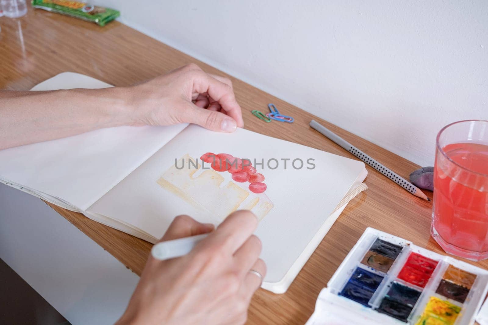 Hobbies and leisure. unrecognizable woman drawing watercolor on hotel room table
