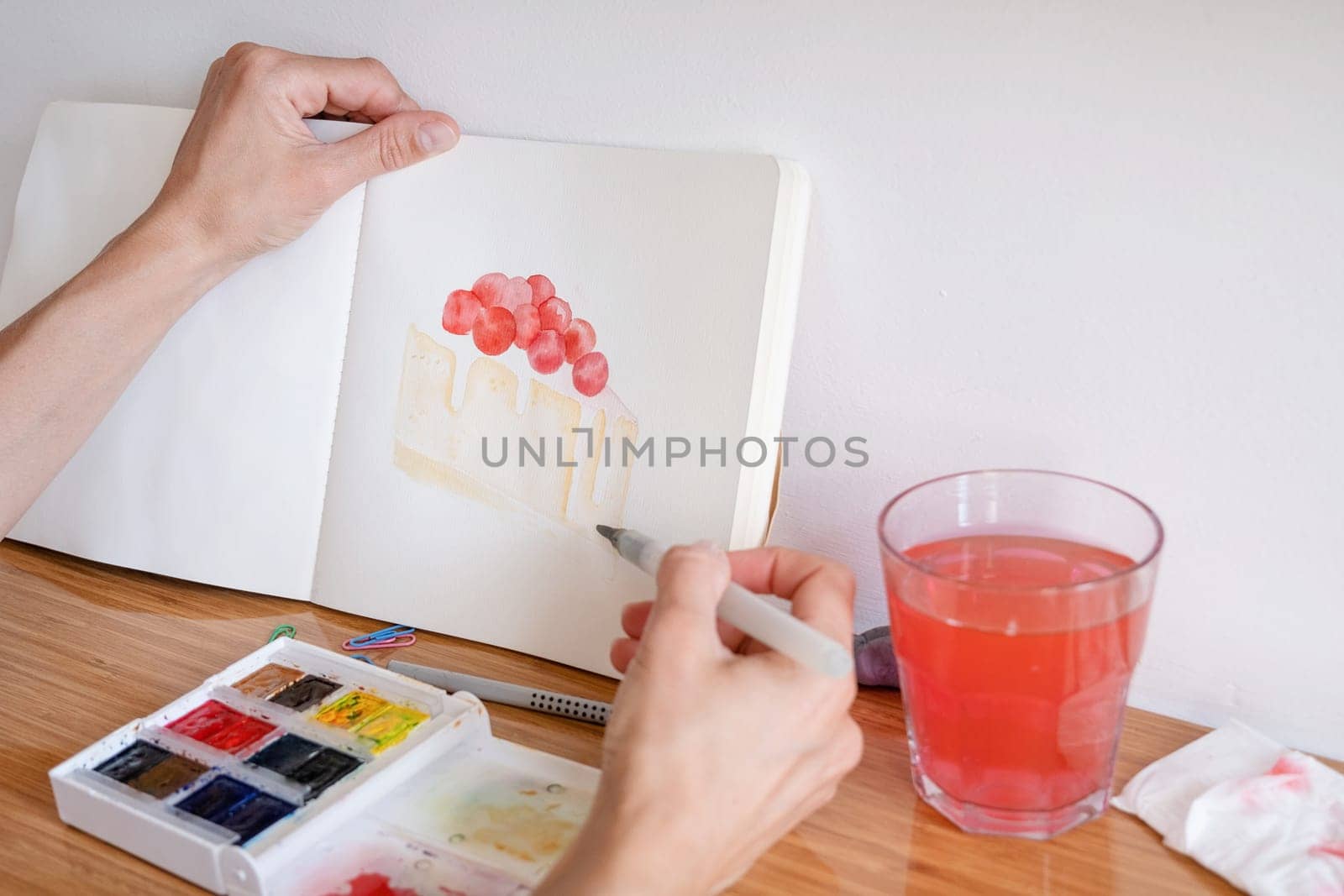 Hobbies and leisure. unrecognizable woman drawing watercolor on hotel room table