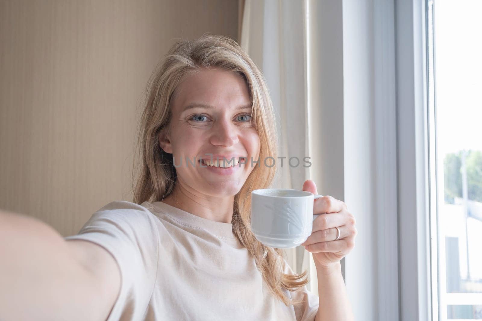 Vacation concept. Happy woman showing her hotel room taking selfie