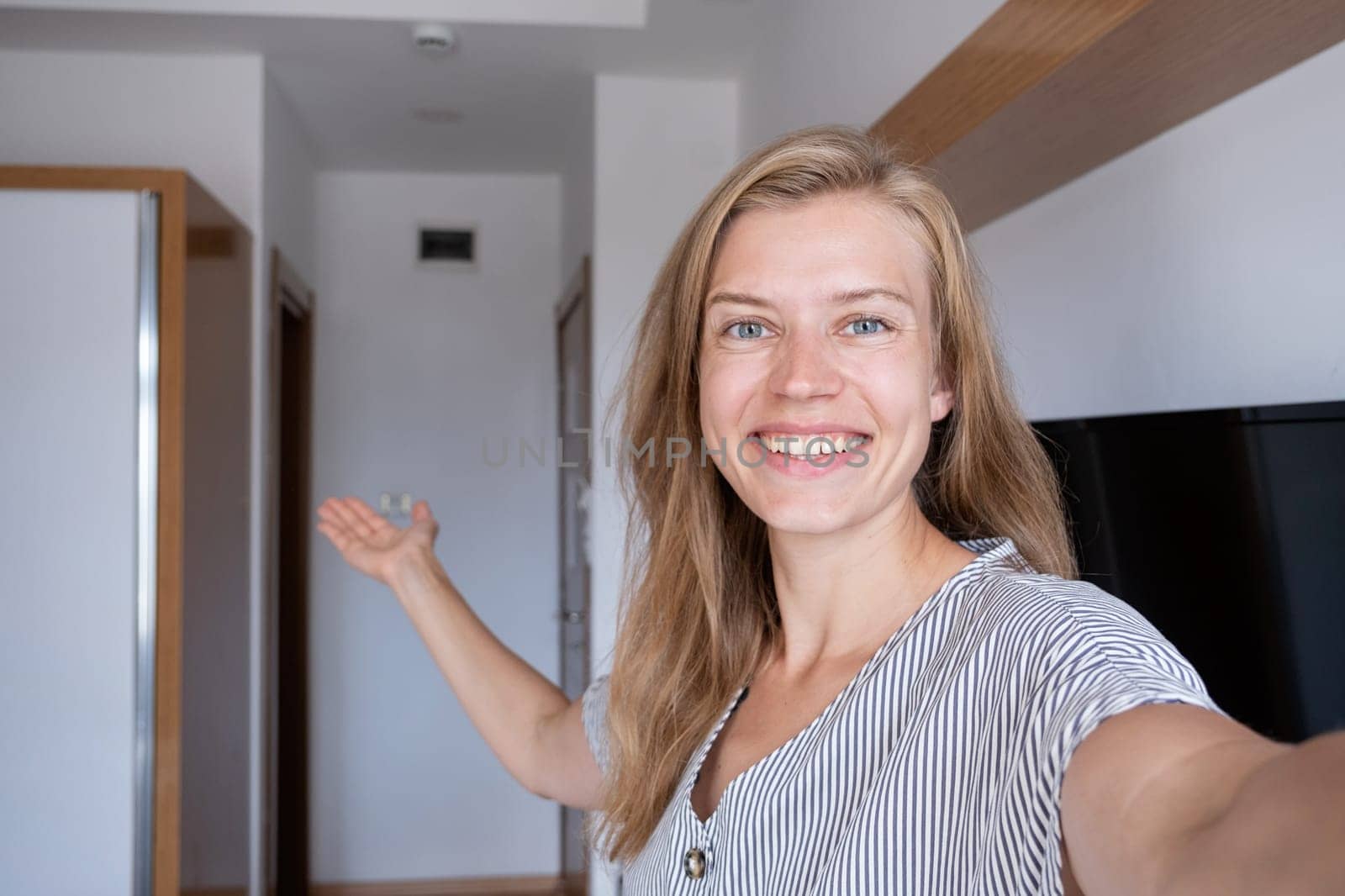 Vacation concept. Happy woman showing her hotel room taking selfie
