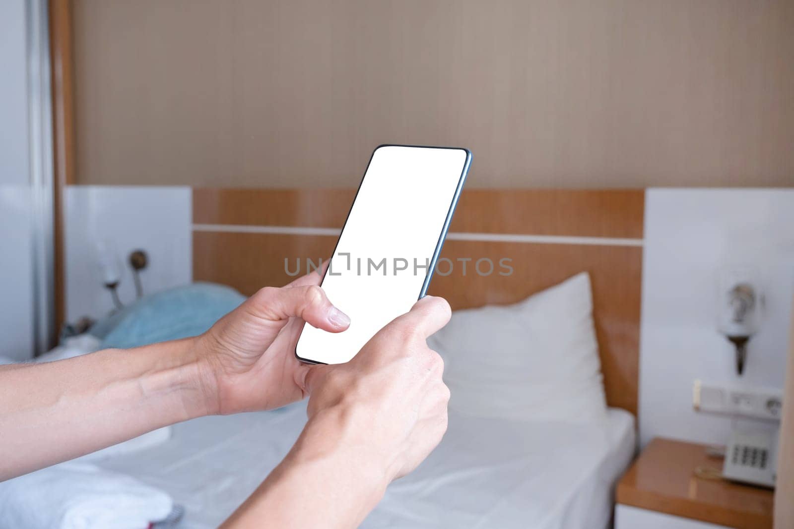 closeup of female hands using smartphone, white blank screen for mockup by Desperada