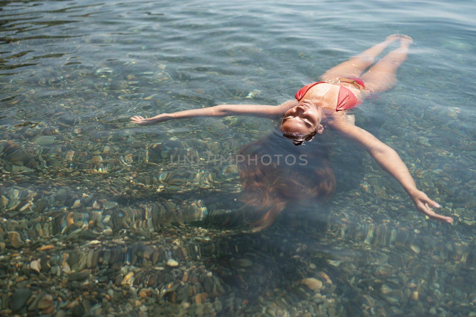 Happy woman sea relaxing floating in transparent sea water on summer holiday. Travel leisure recreation lifestyle, female in nature
