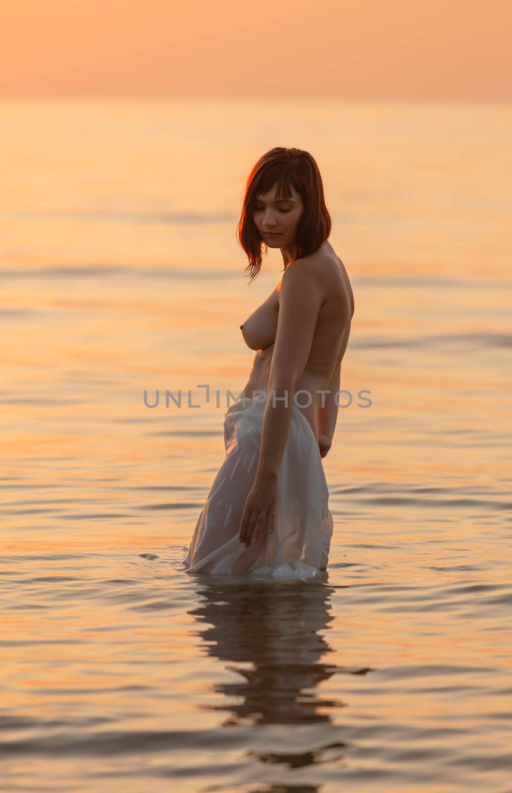 Youth, beauty and nudity. Young naked woman enjoying nature on the seashore