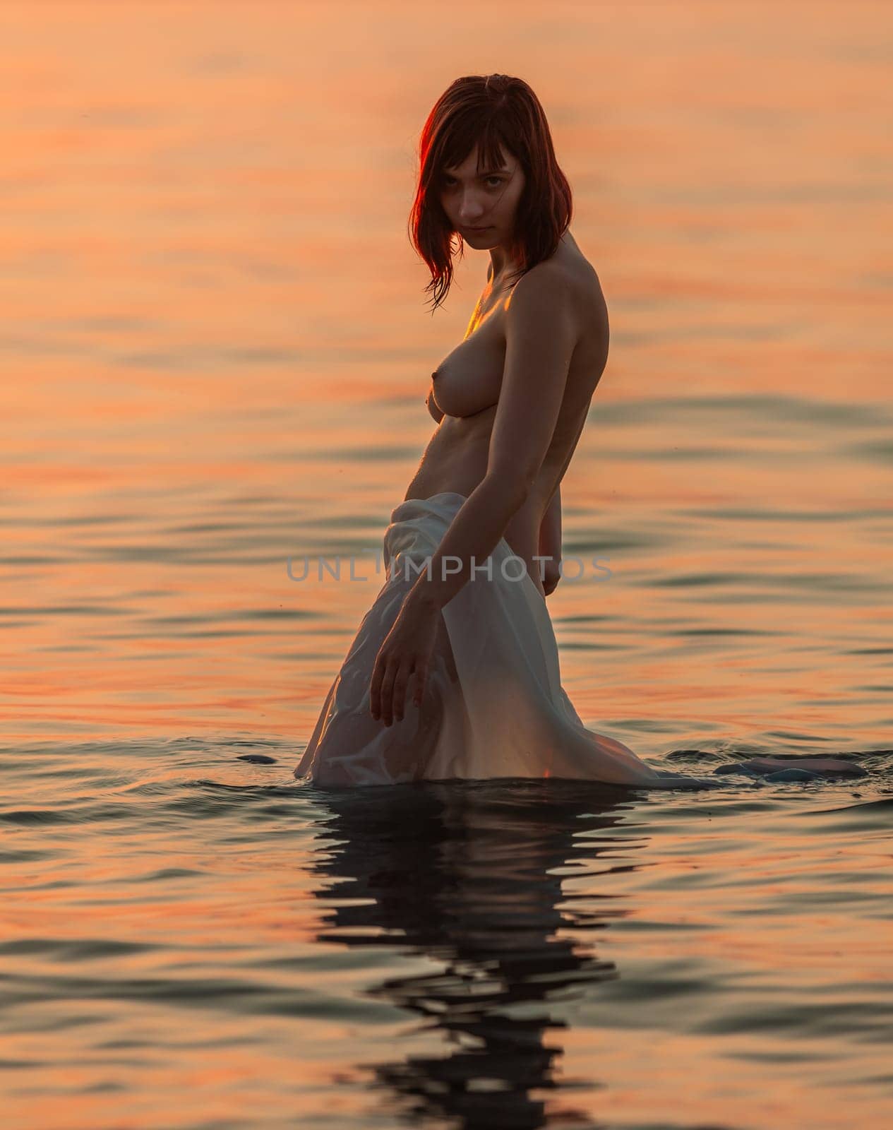 Young naked woman enjoying nature on the seashore by palinchak