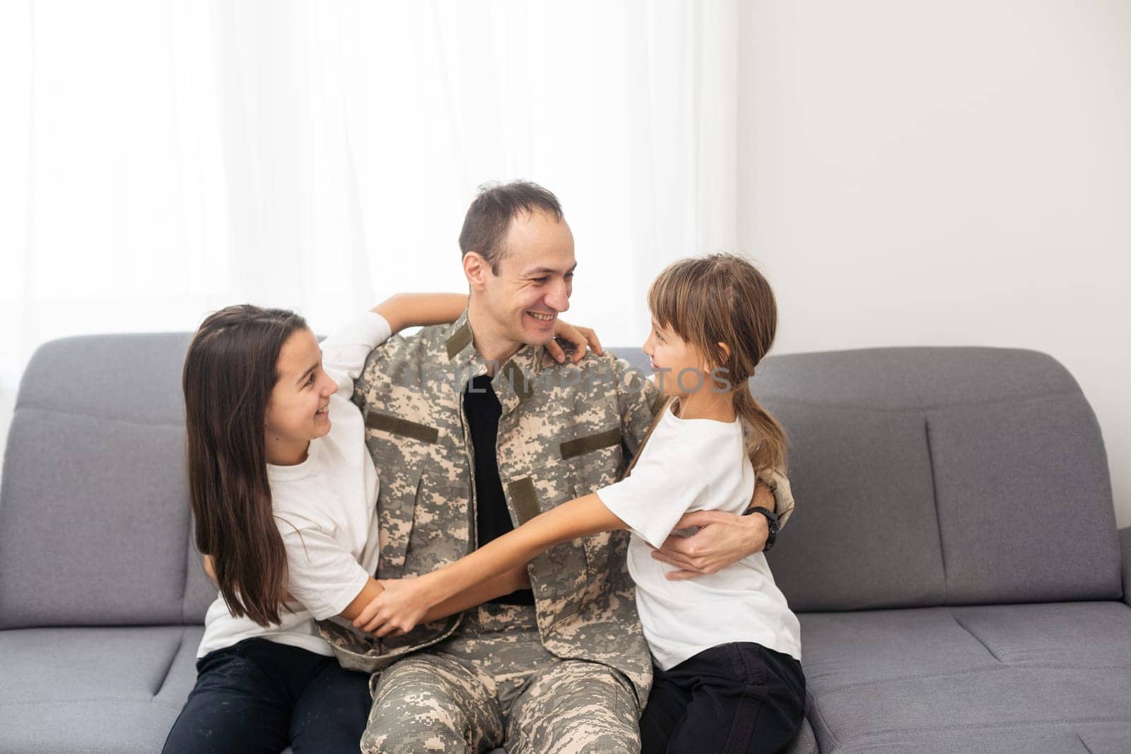 Little girl with her military father at home. High quality photo