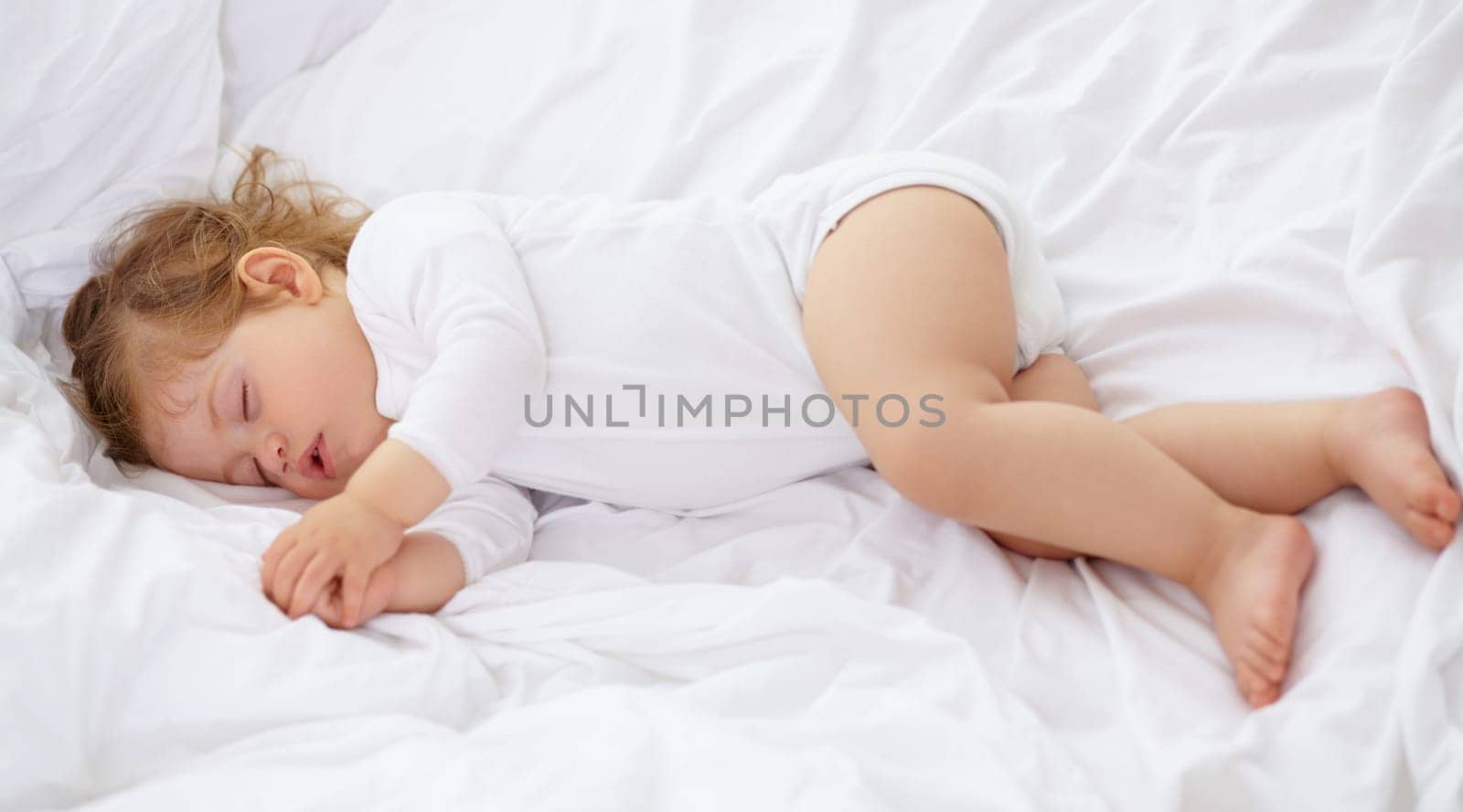 Baby, kid and sleeping on bed for calm break, peace and dream to relax at home from above. Tired, cozy or young child asleep for newborn development, healthy childhood growth and rest in nursery room.