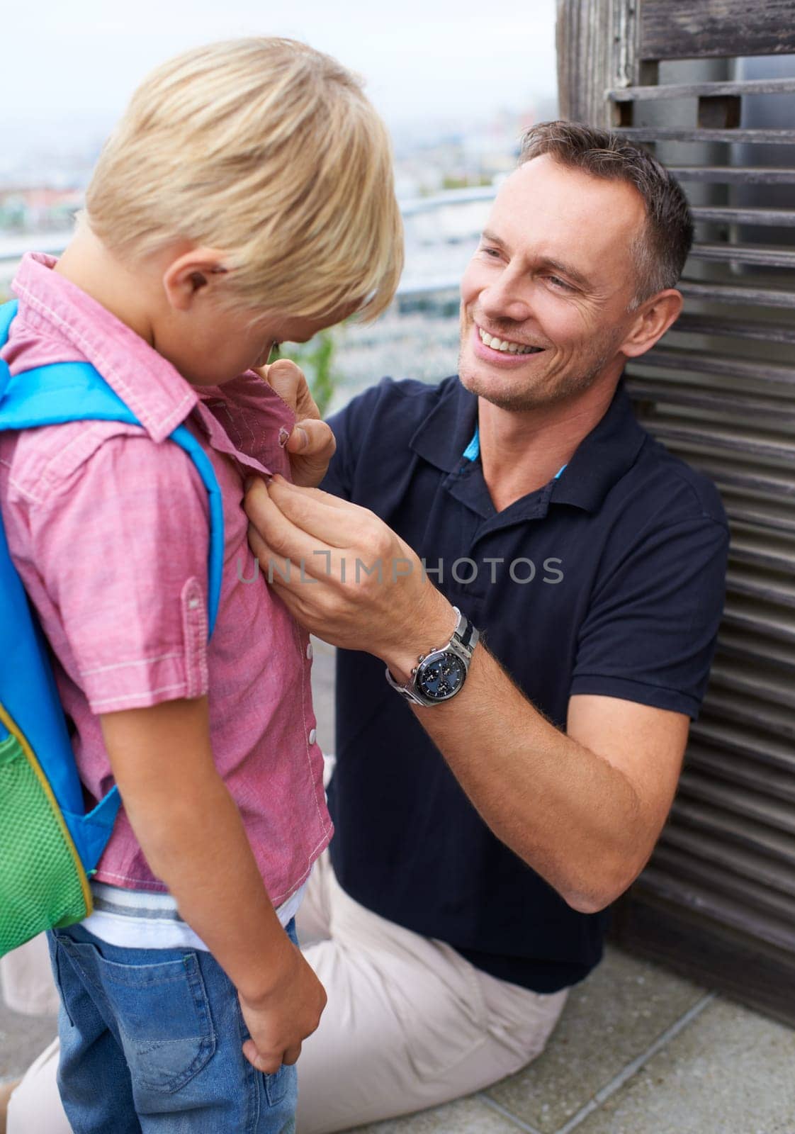 Helping, father and child ready with backpack for school in morning, routine and outdoor at home. Happy, dad and dressing kid to start learning in education with support, care and pride together.