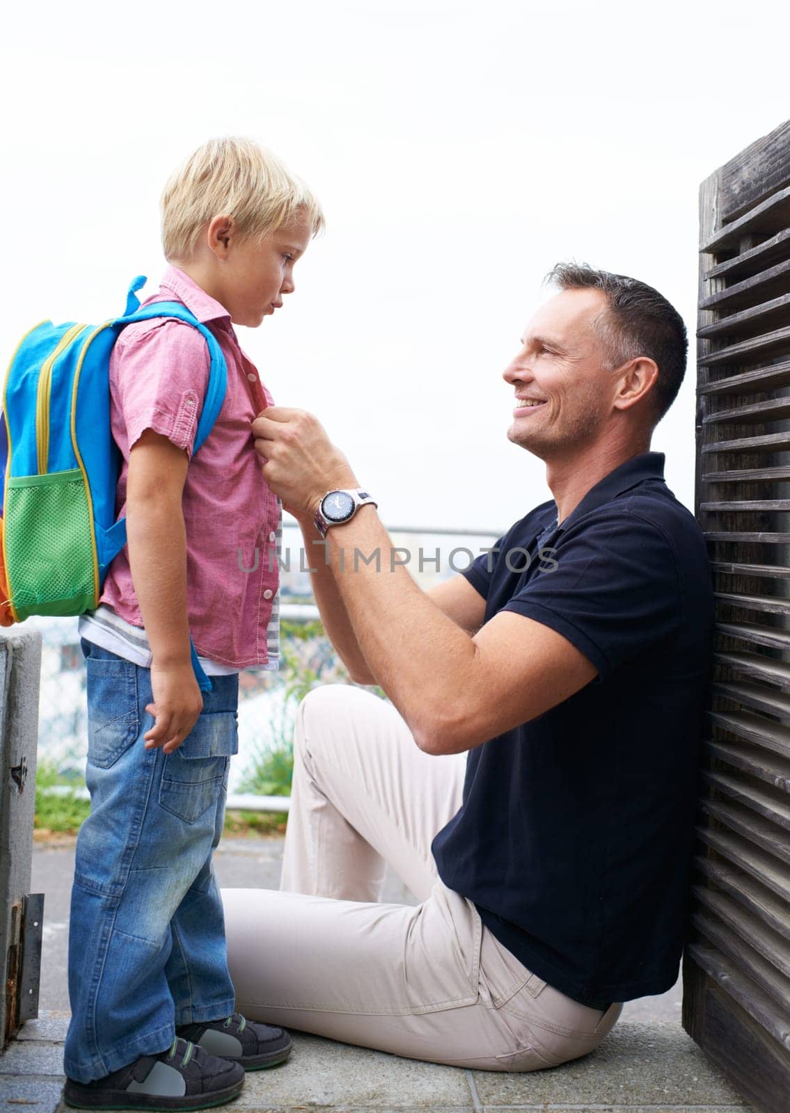 Father, helping and child ready with backpack in morning and back to school routine at home. Dad, love and pride for kid to start learning in education with support, care and happiness together by YuriArcurs