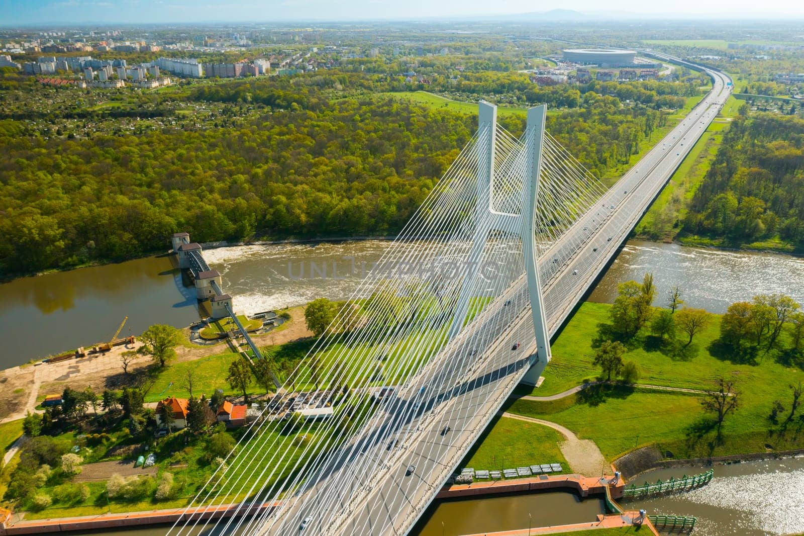 Cars drive on cable-stayed Redzinski Bridge over river by vladimka