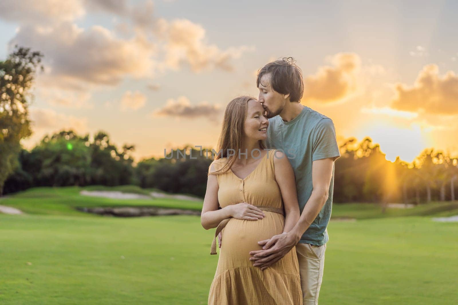 A blissful moment as a pregnant woman and her husband spend quality time together outdoors, savoring each other's company and enjoying the serenity of nature.