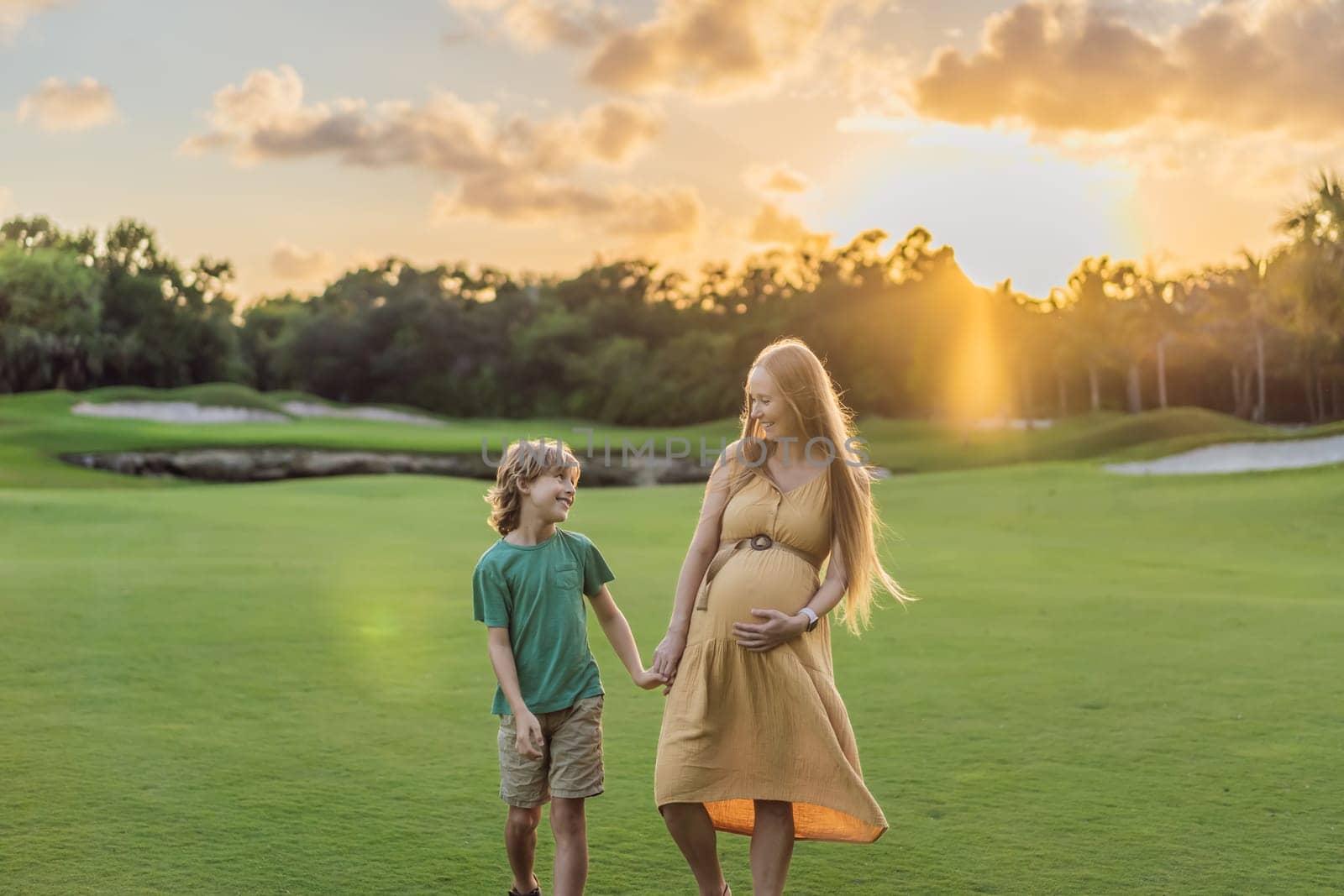 Heartwarming outdoor bonding as a pregnant mom and her son enjoy quality time together, savoring the beauty of nature and creating cherished moments.