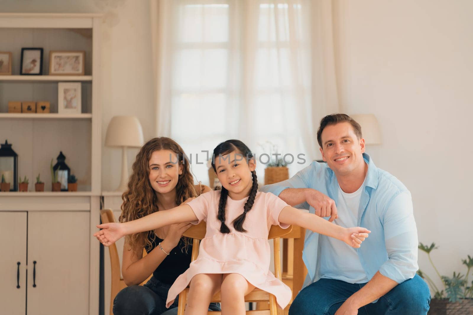 Happy family portrait with little girl smiling, looking at camera. Synchronos by biancoblue