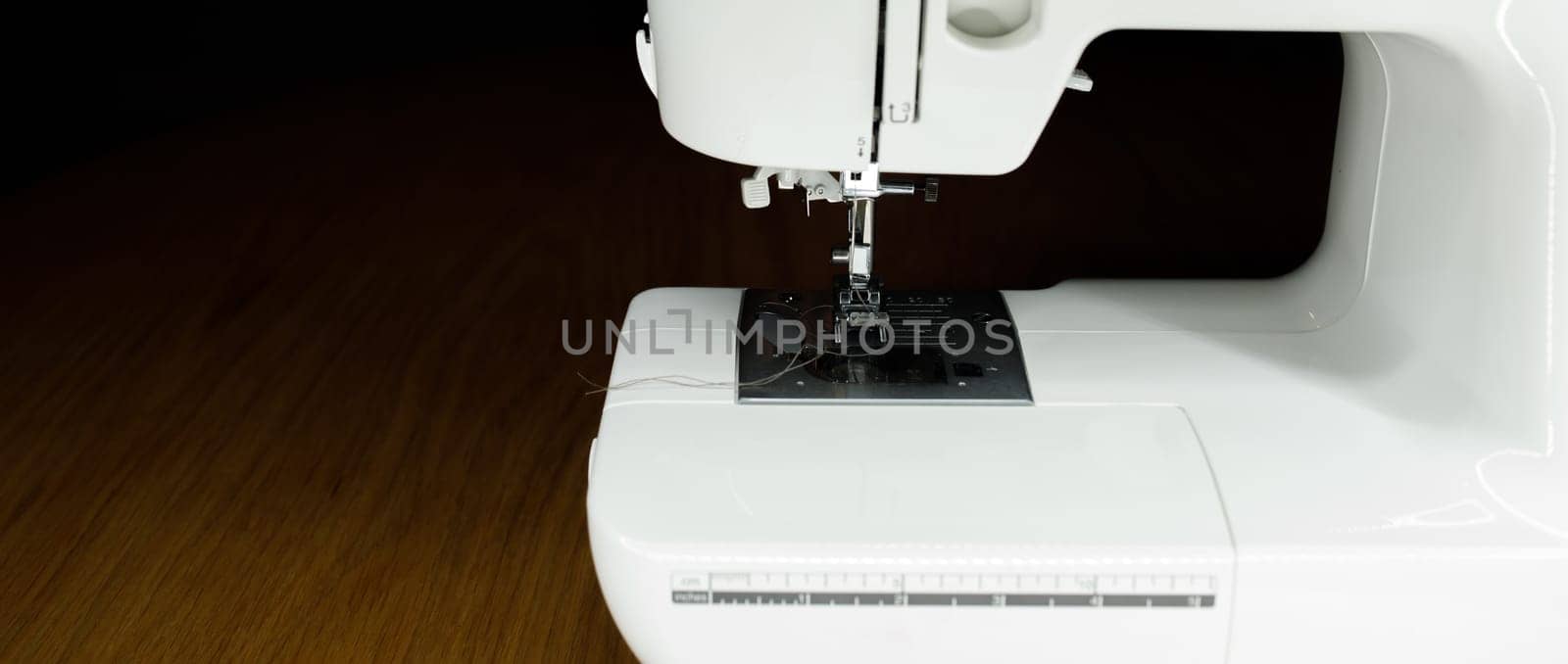 white sewing machine on a wooden table. High quality photo