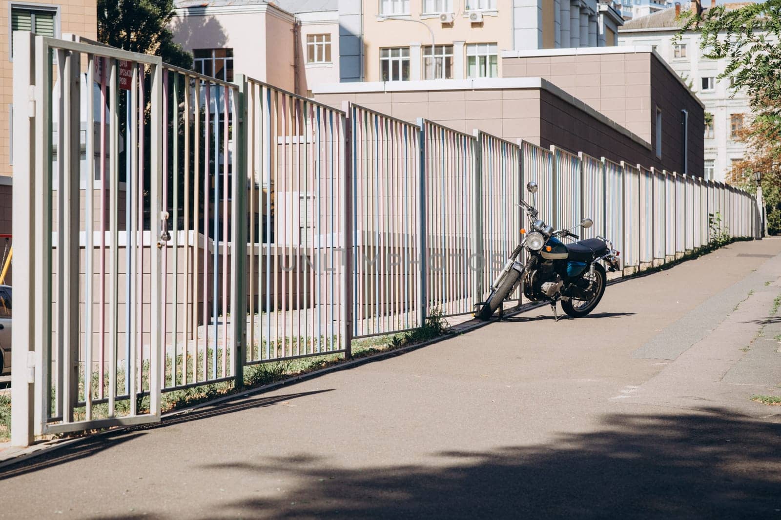 motorcycle near a long fence. High quality photo