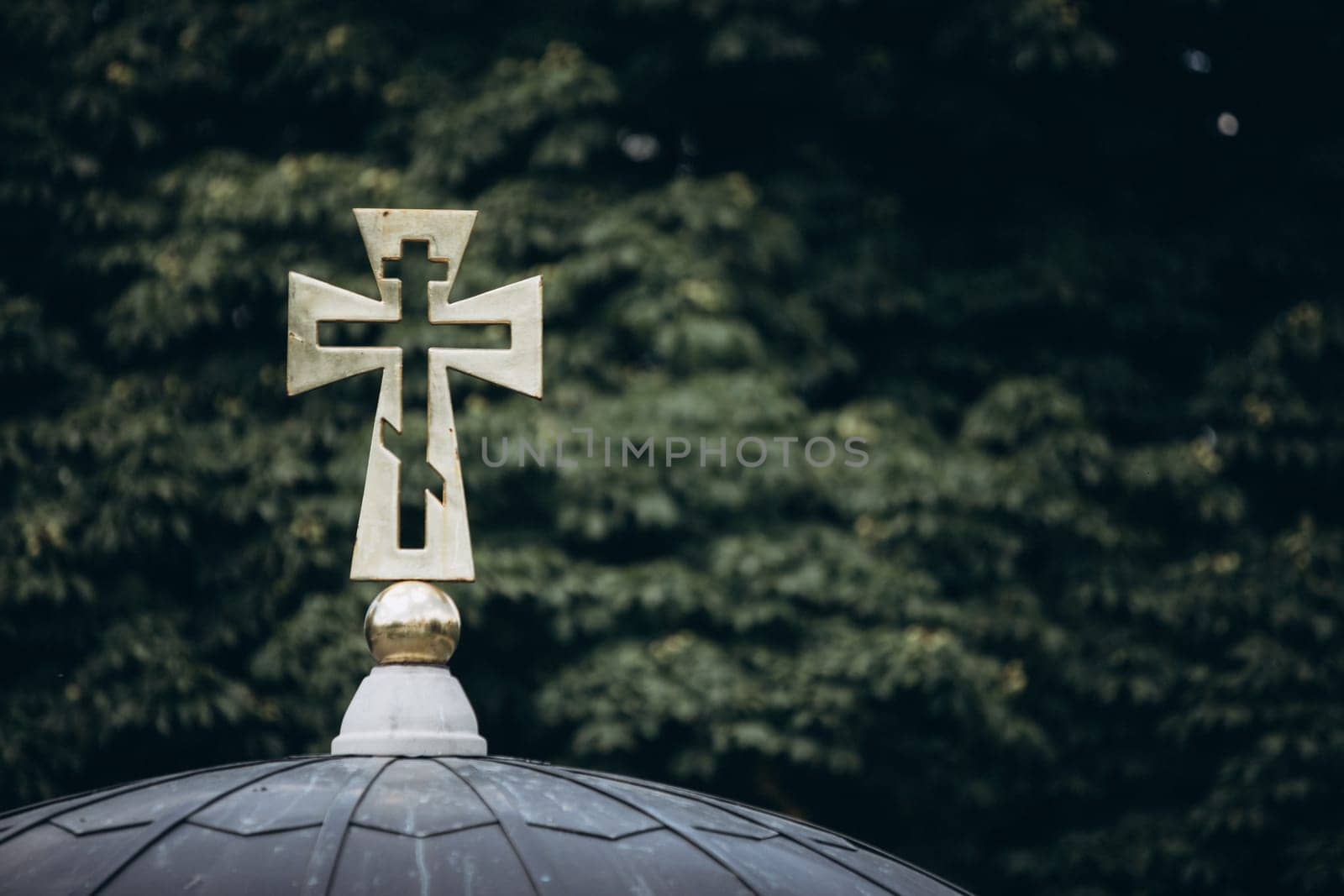 cross on a background of green branches. High quality photo