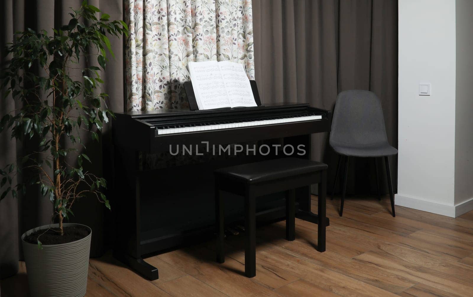black piano and sheet music, at home. High quality photo