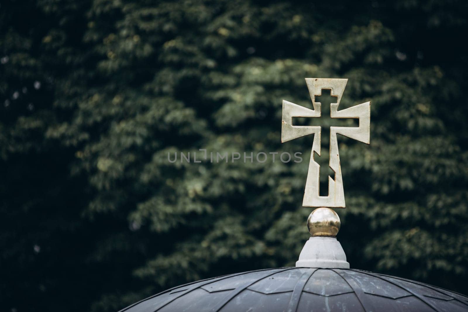 cross on a background of green branches. High quality photo