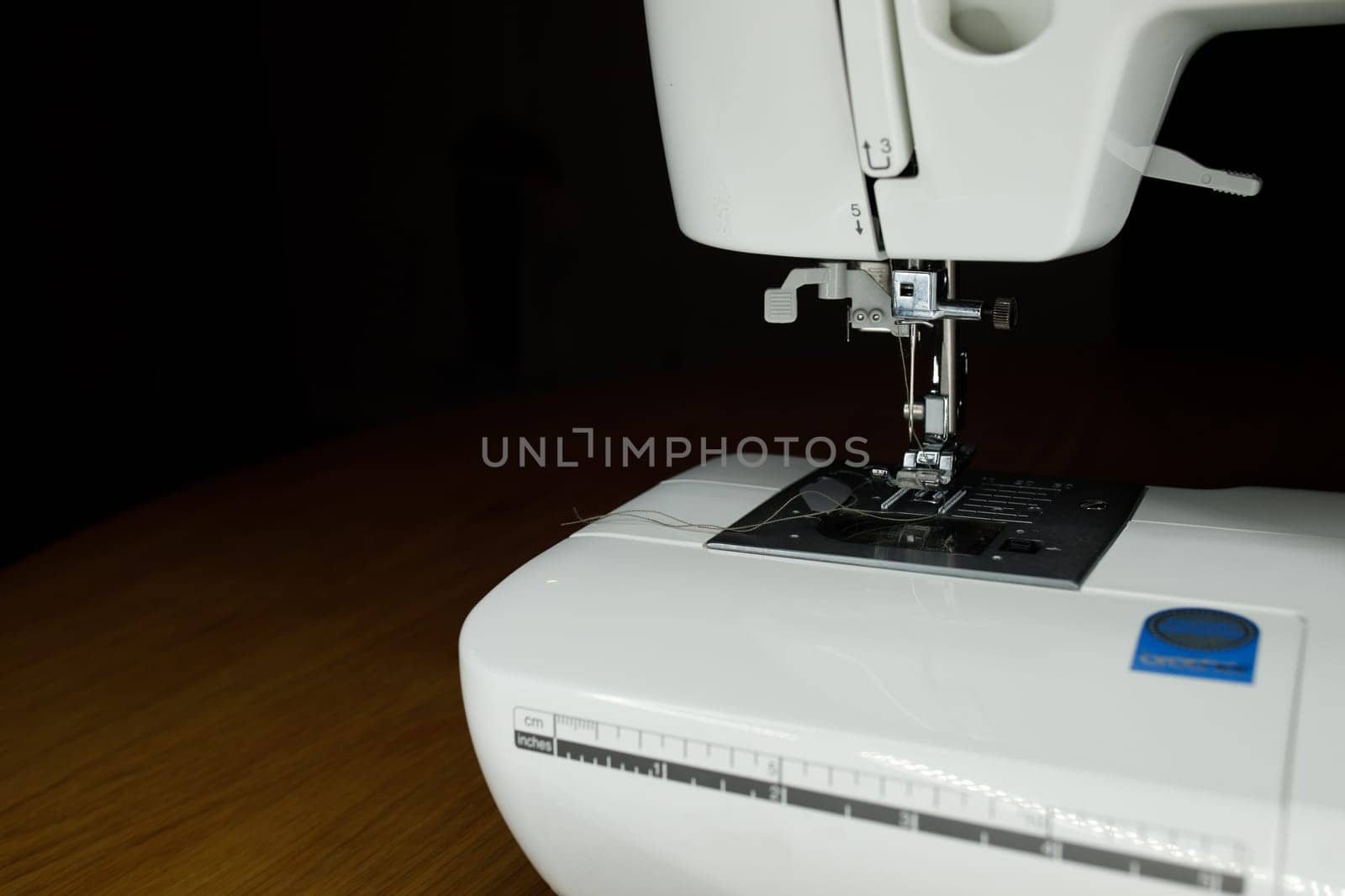 white sewing machine on a wooden table. High quality photo