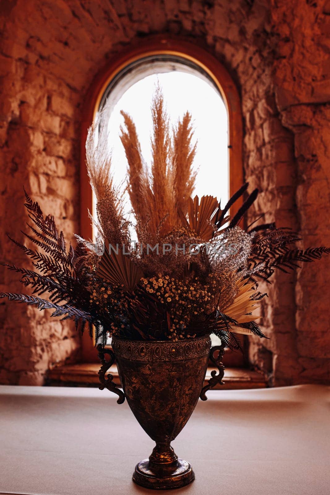 bouquet in a vase is very modern in muted tones against the background of the window. High quality photo