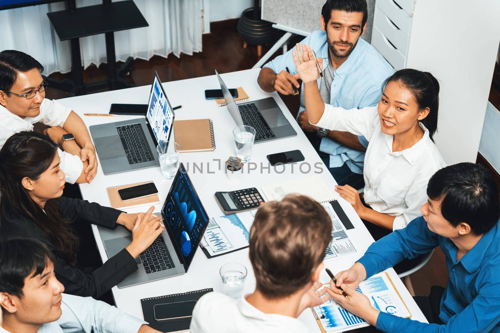 Office worker raise hand up asking for question during business meeting on data analysis using BI or business intelligence software for marketing and strategic planning. Prudent