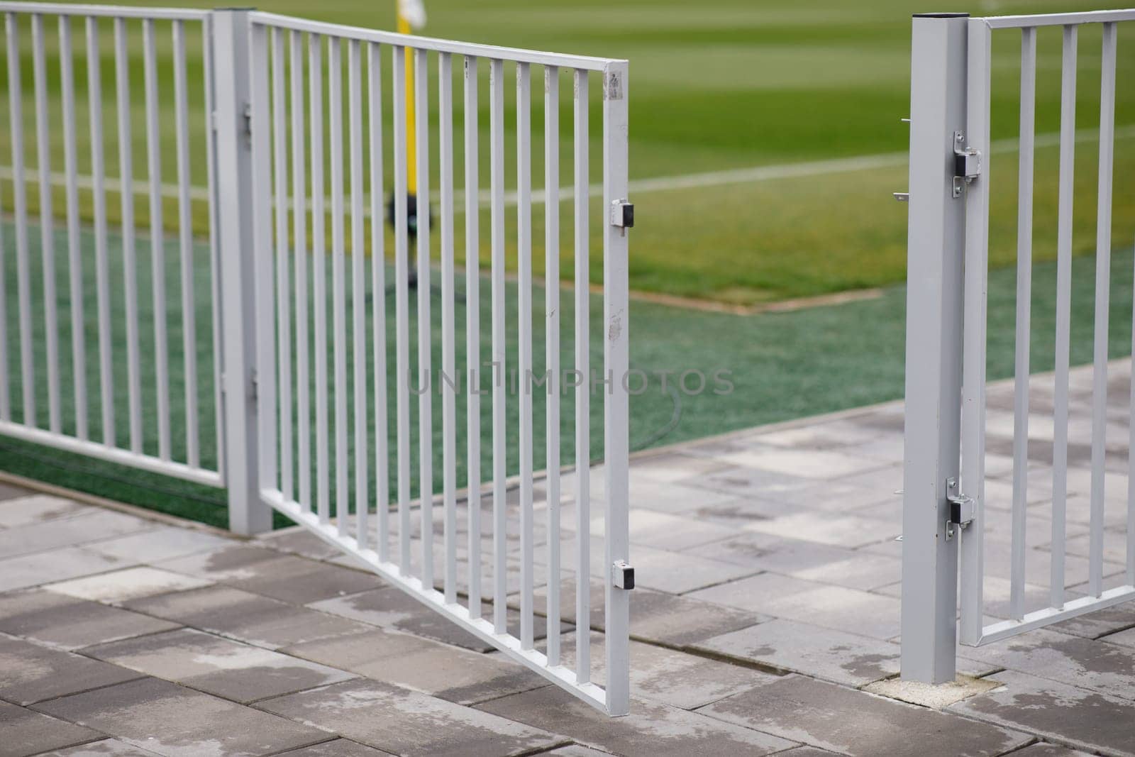 the fence of the football field is a folded wicket. High quality photo