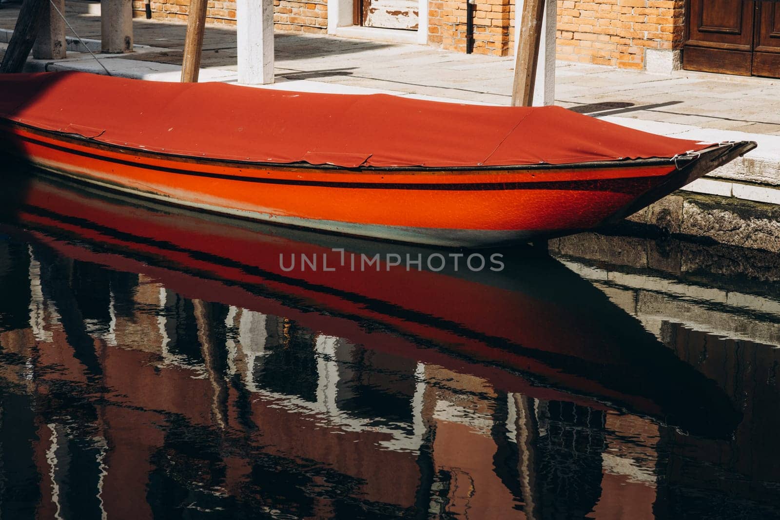 a boat is moored on a canal in Venice. High quality photo