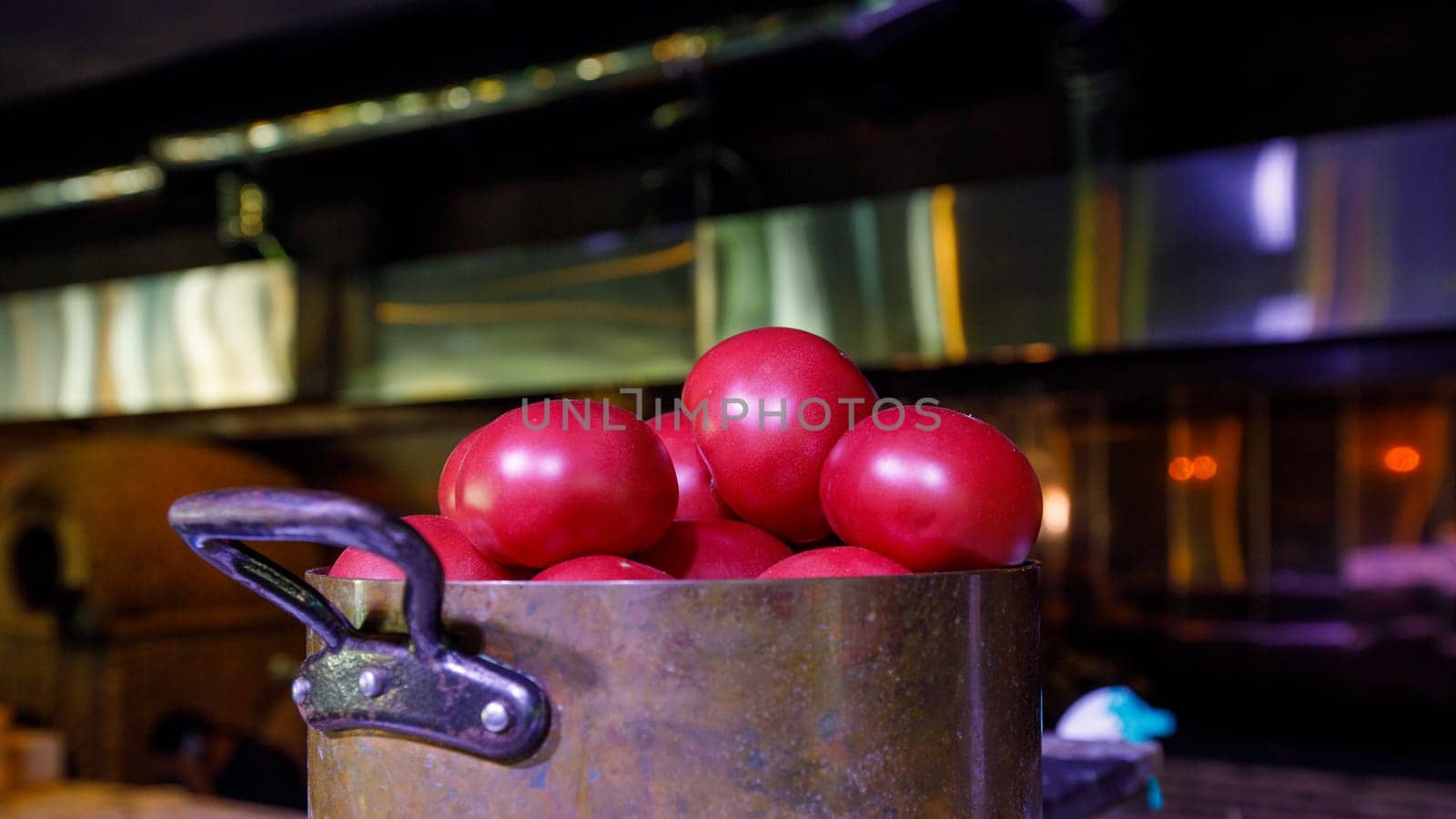 tomato in a saucepan, muted dark background. High quality photo