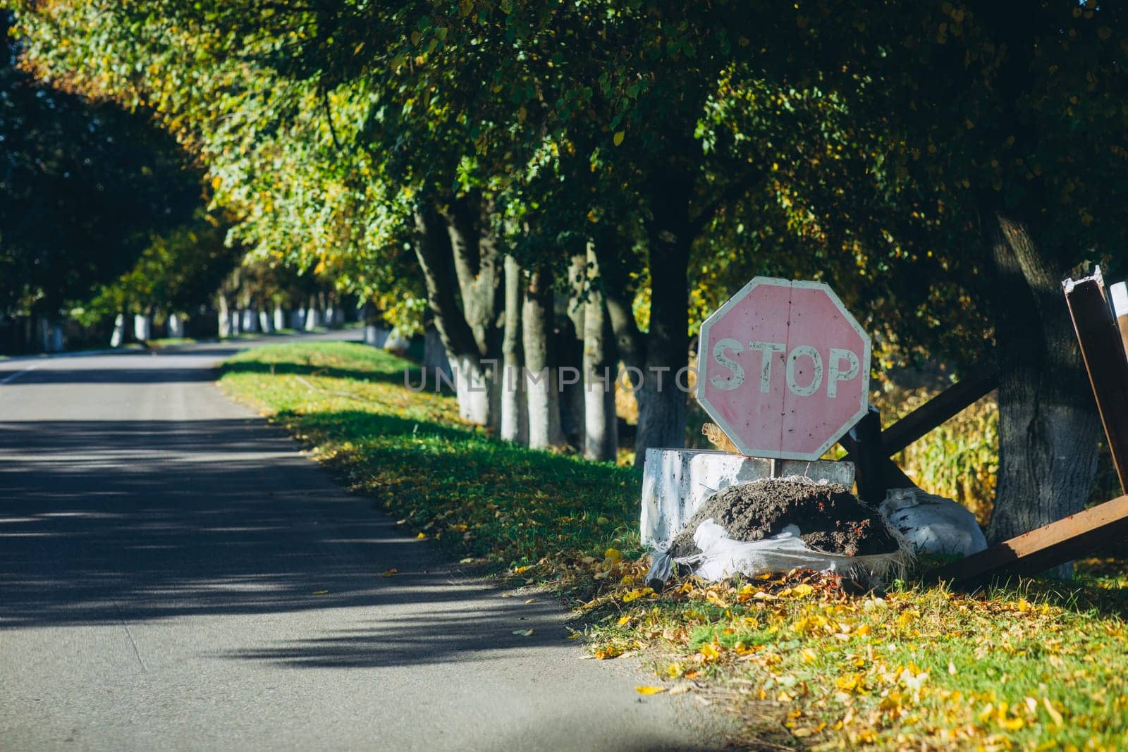 stop sign near the road and anti-tank hedgehogs. High quality photo