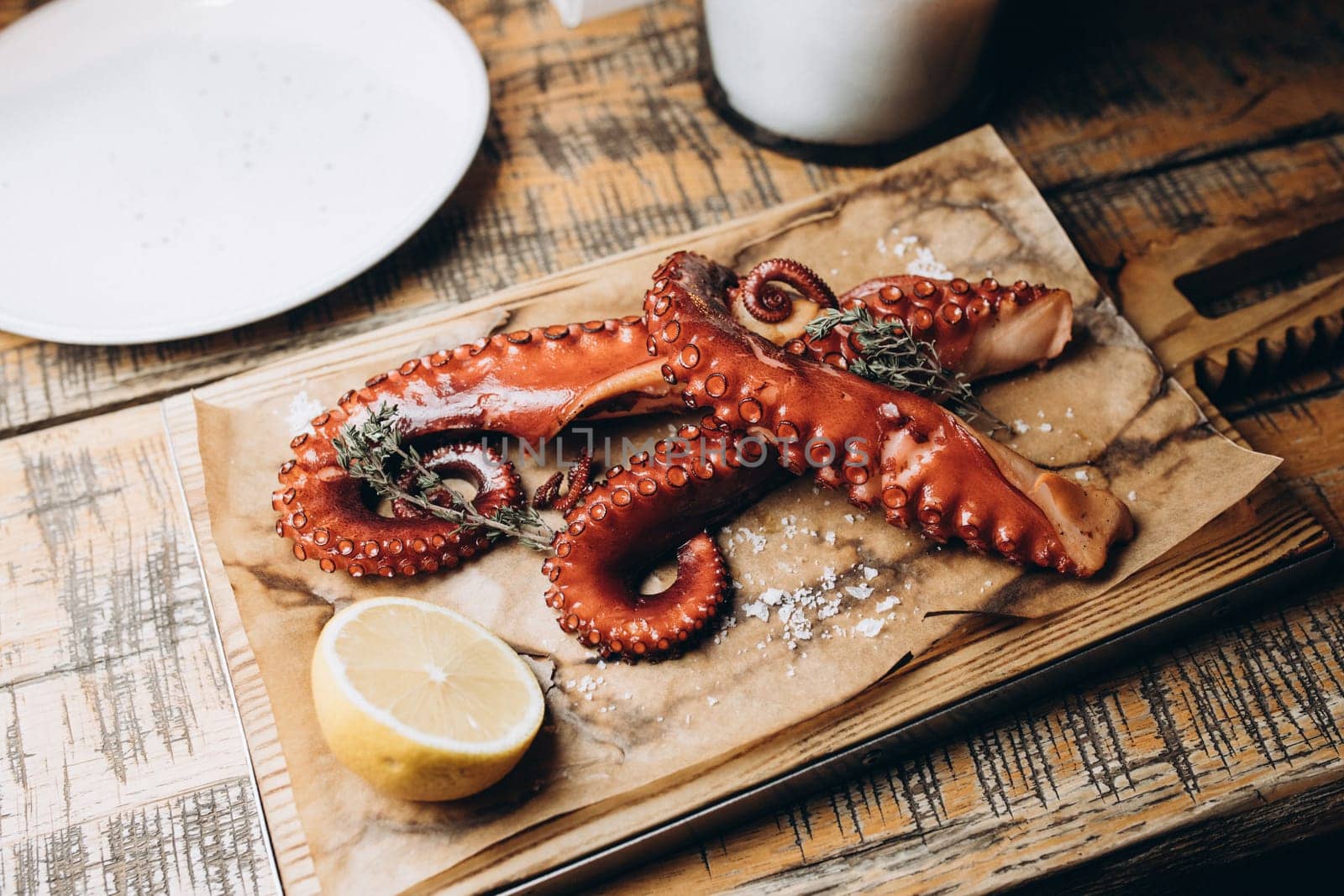 octopus and lemon platter on utensils. High quality photo