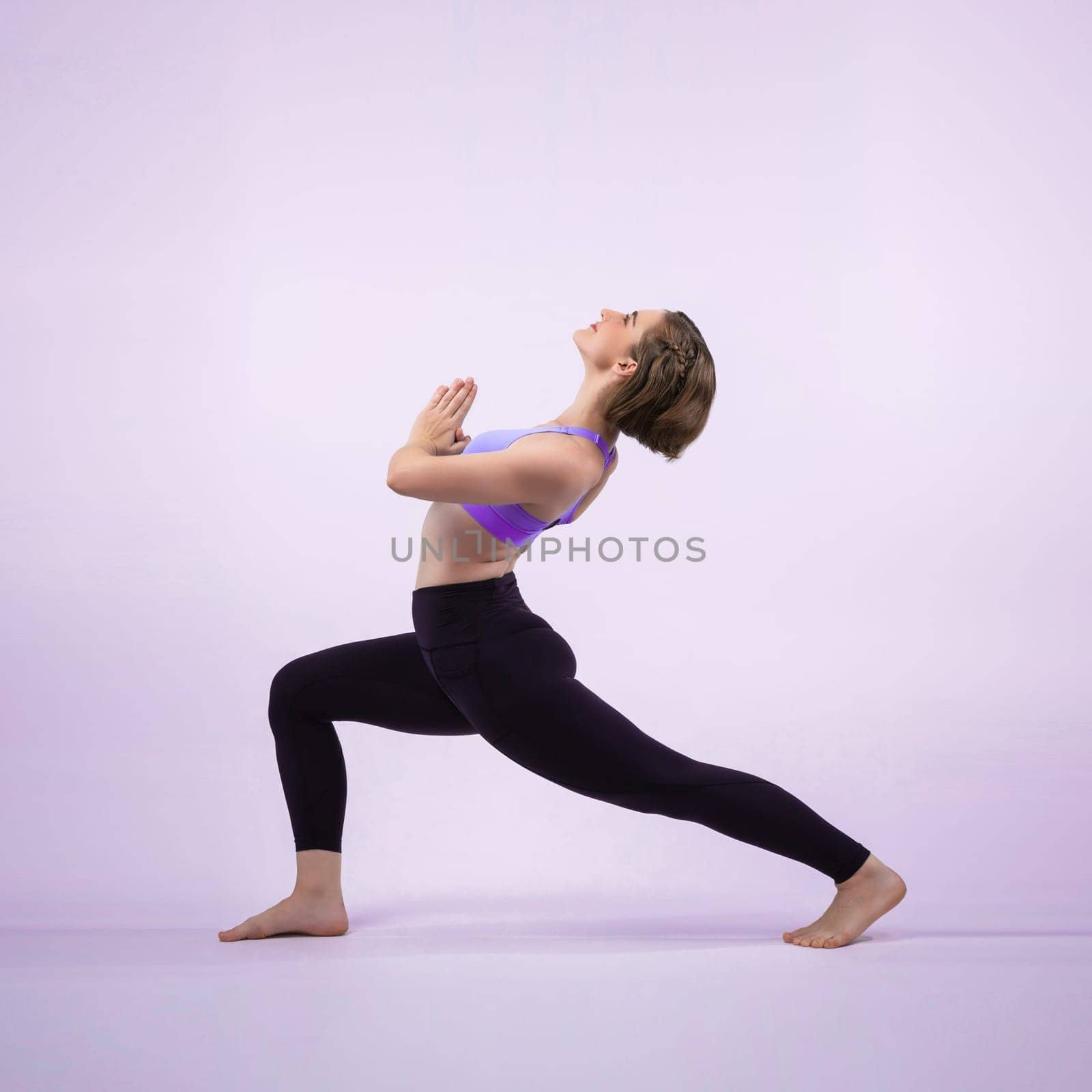 Full body length gaiety shot athletic and sporty woman doing yoga by biancoblue