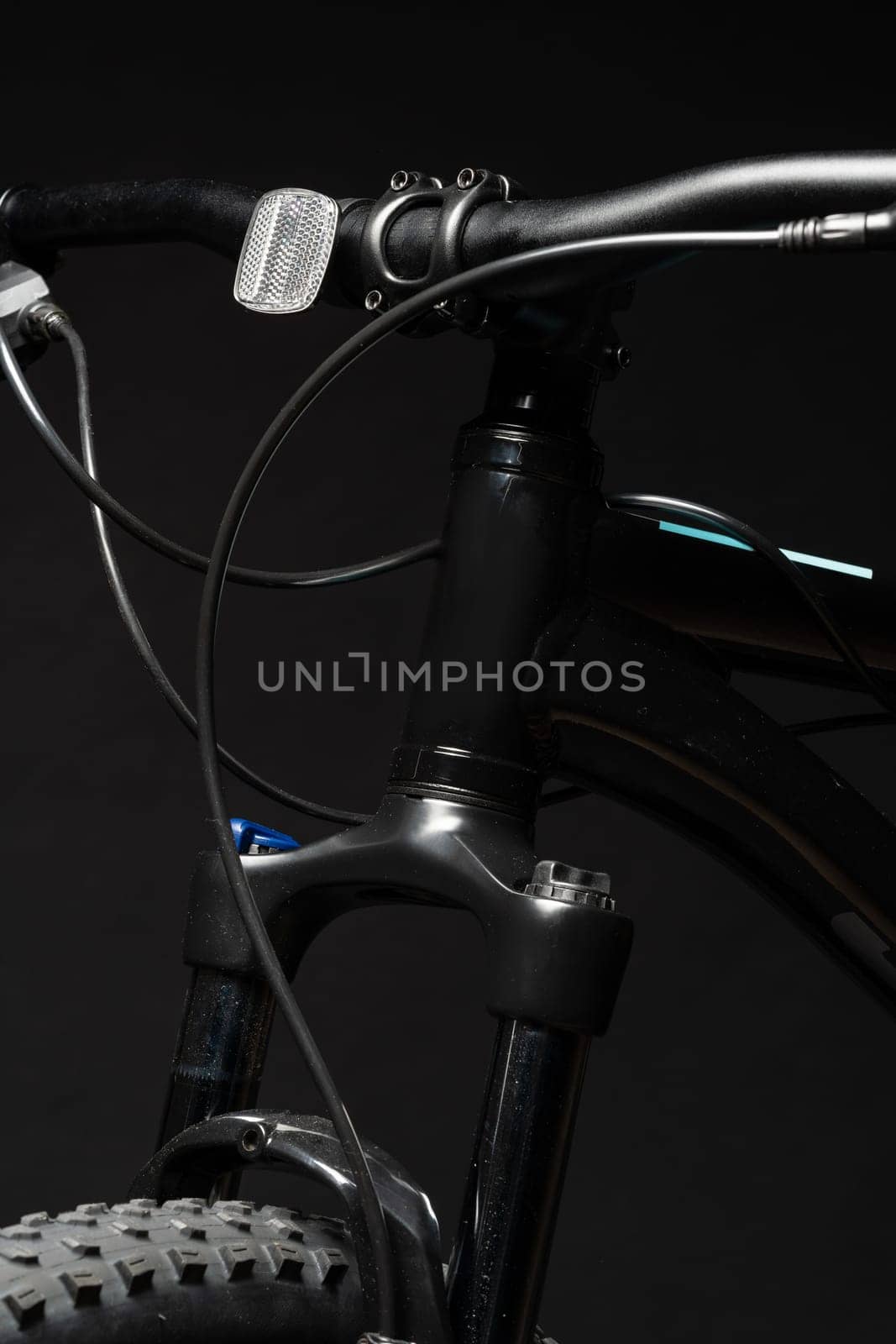 Close up photo of a bicycle against black background